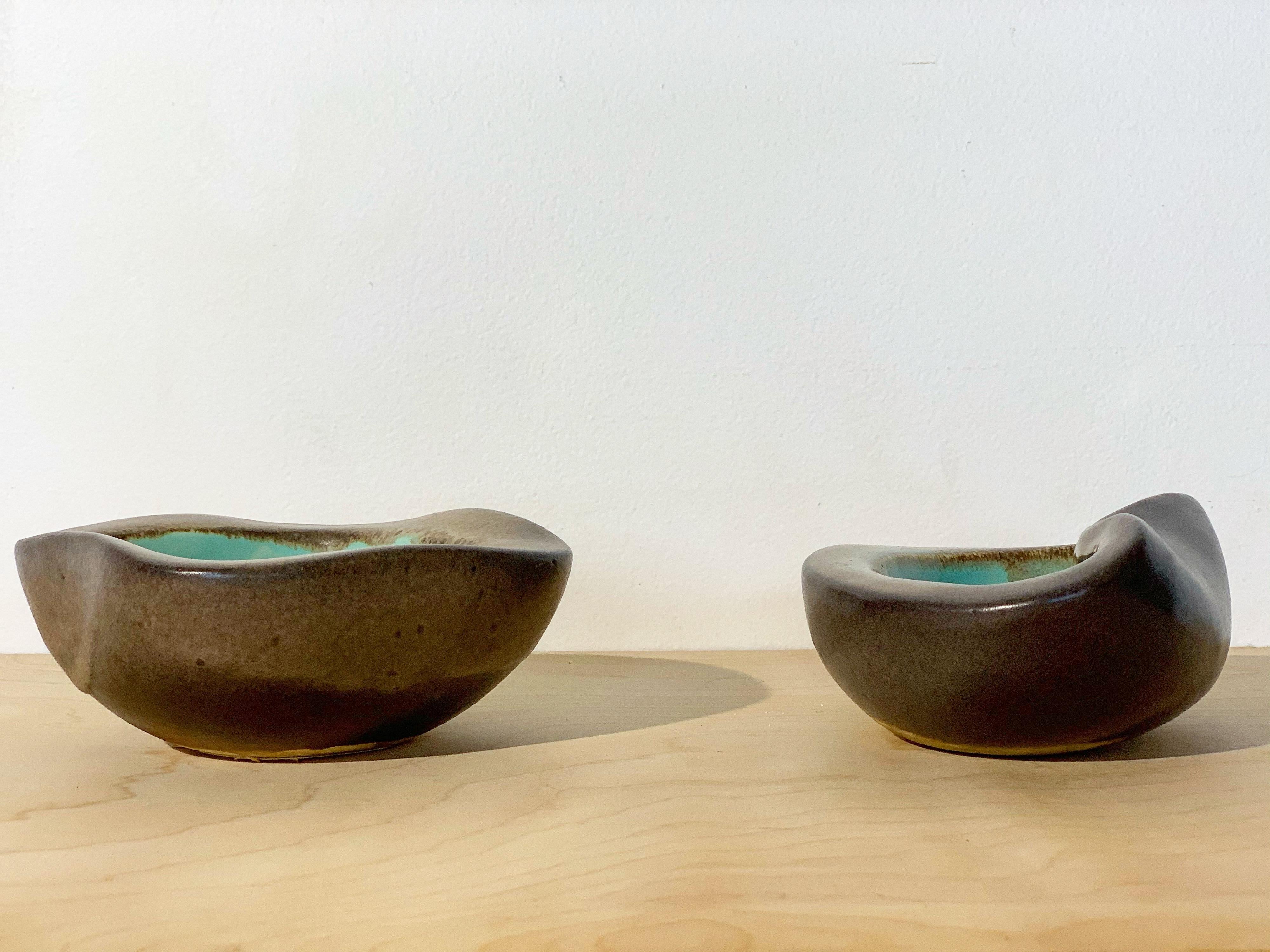 Collection of two rare examples of stoneware from Bauer Pottery by Russel Wright. Produced in Bauer's Atlanta facility 1945-1946. Seldom seen turquoise color way. Stout and heavy while maintaining Wright's organic and modern aesthetic. Excellent