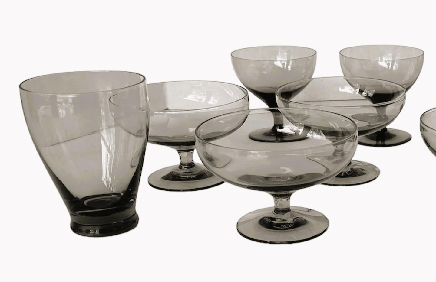 Mid Century Modern grouping of 12 American Modern glasses designed by Russel Wright and manufactured by Morgantown. Consisting of 12 Granite Gray – 2 juice glasses, 6 dessert/Champagne and 4 wine goblet all in Very Good condition. Since they are