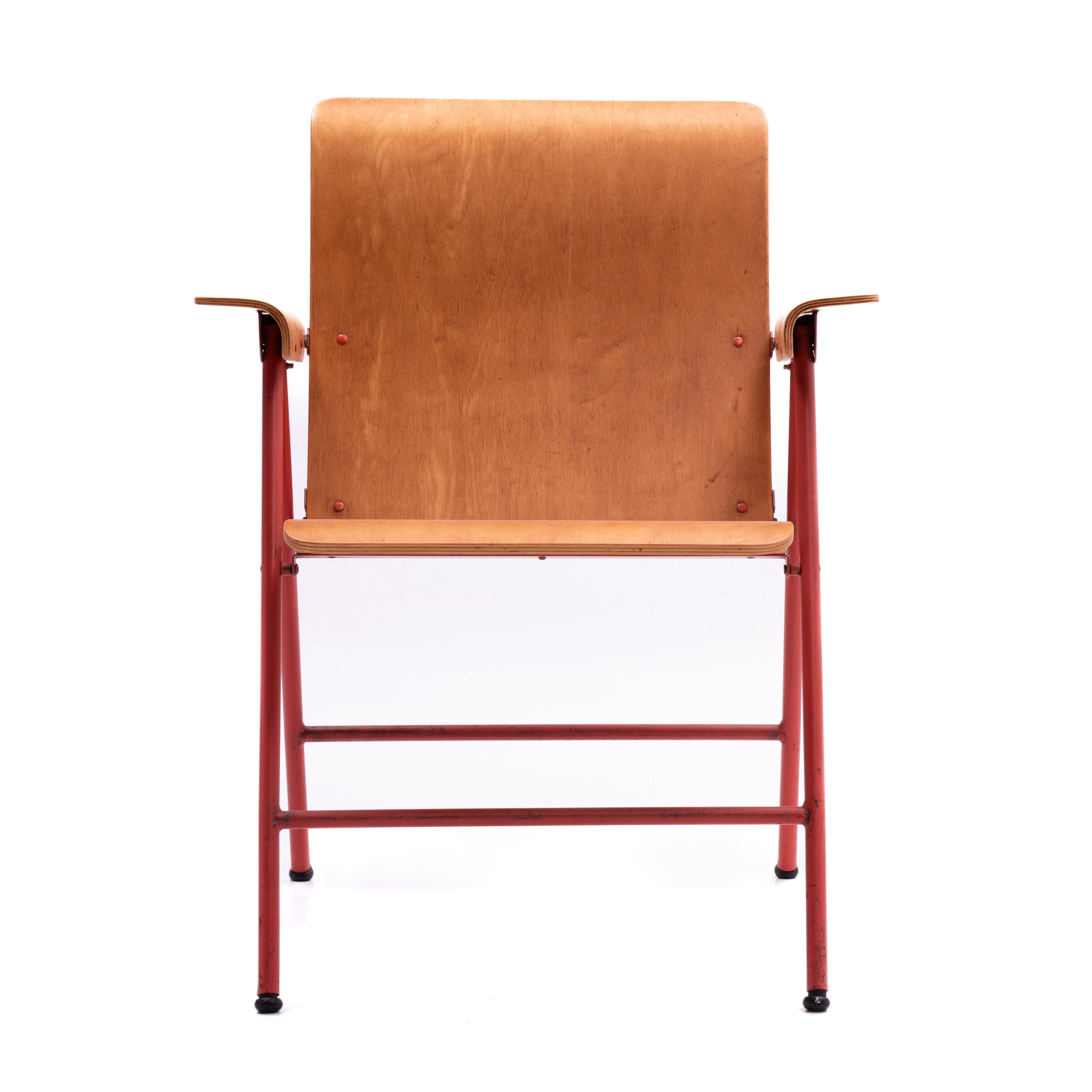 An iconic Russel Wright for Shwayder Brothers/ Samsonite Samson Chairs folding plywood armchair in the original salmon color painted metal frame. 