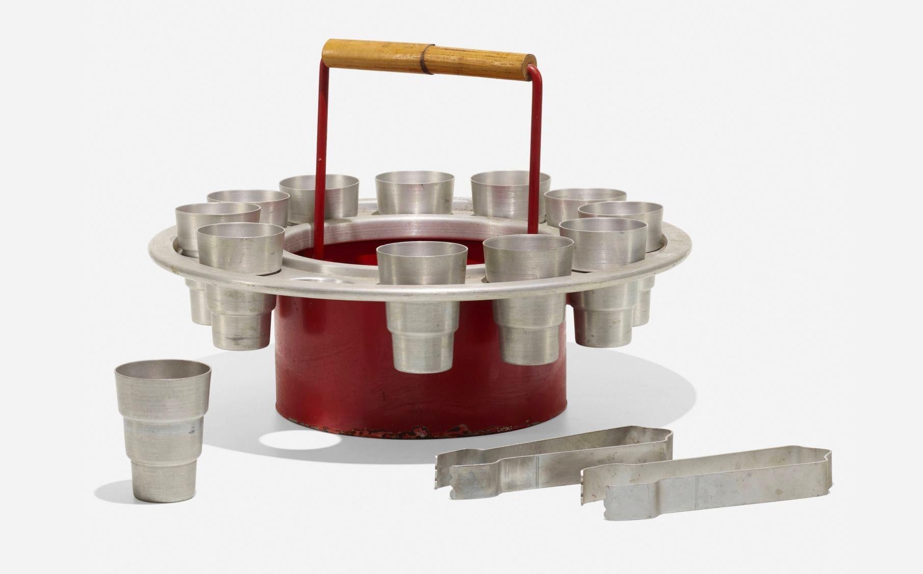 Russel Wright Rare Ballyhoo Ice Bucket Set 1930's
This exceptional Ballyhoo Ice Bucket set is a rare find. The set includes twelve cups, two ice tongs, and a ice bucket featuring a removable service tray. All thirteen pieces showcase the impressed