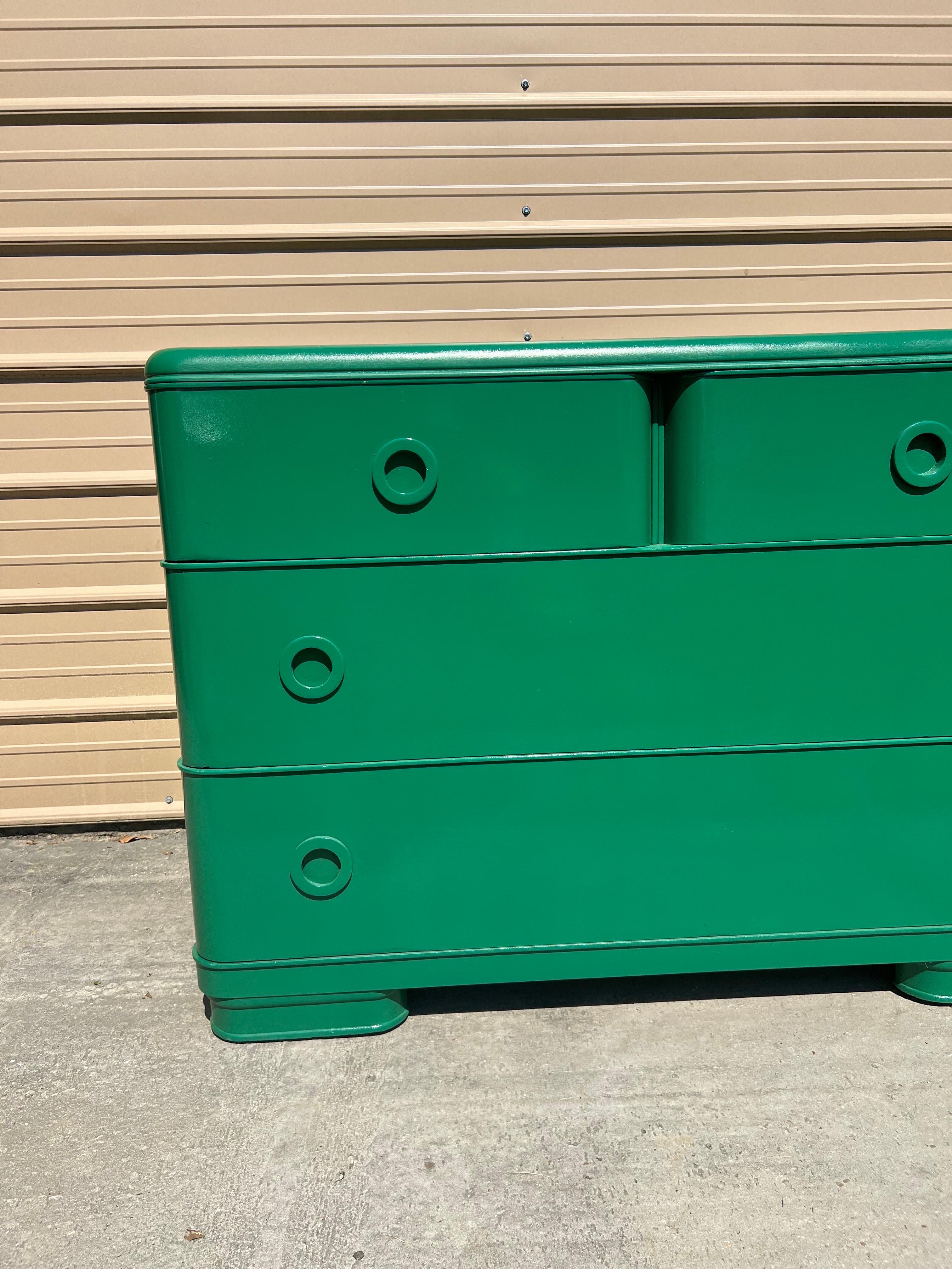 This stunning art deco Russel Wright style dresser is super sexy and has been carefully restored and lacquered in a gloss Benjamin Moore “Deep Green”.  Deep green is described as “A dark, distinguished green with a subtle teal cast.” The sexy curves