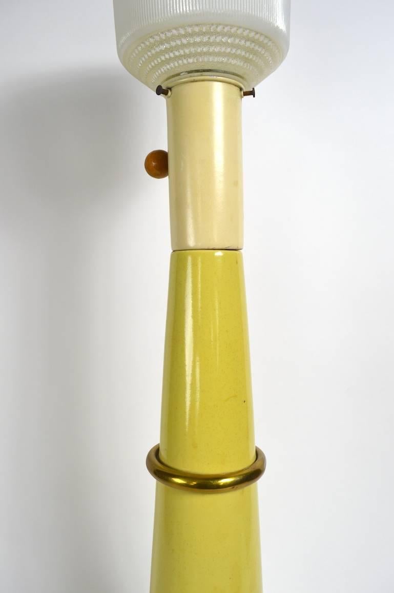 Tall conical ceramic table lamp designed by Russel Wright. This example is in very good original condition, with one replaced screw and one replaced grommet, shade not included.