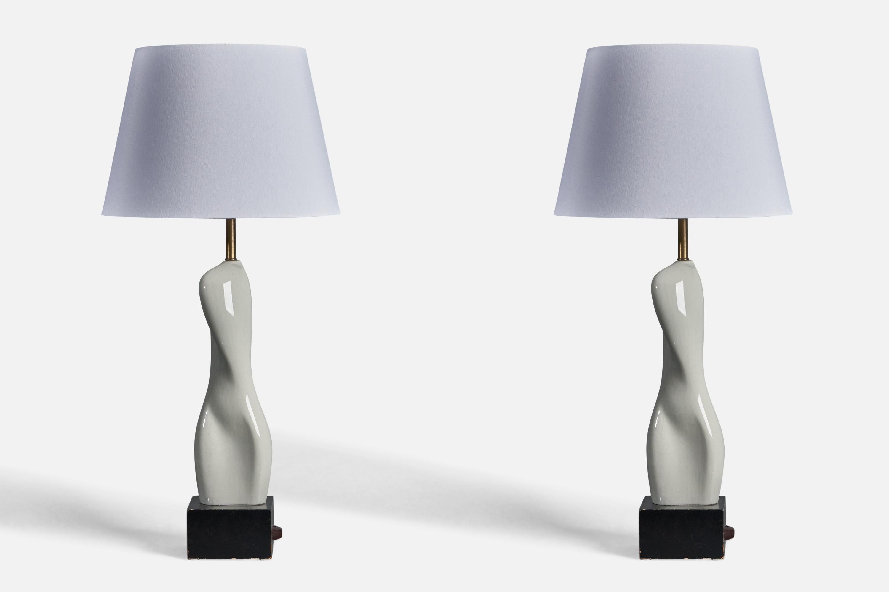 A pair of freeform grey-glazed ceramic, brass and black-lacquered wood table lamps, designed by Russel Wright, USA, 1940s.

Dimensions of Lamp (inches): 29.75” H x 8” Diameter
Dimensions of Shade (inches): 10