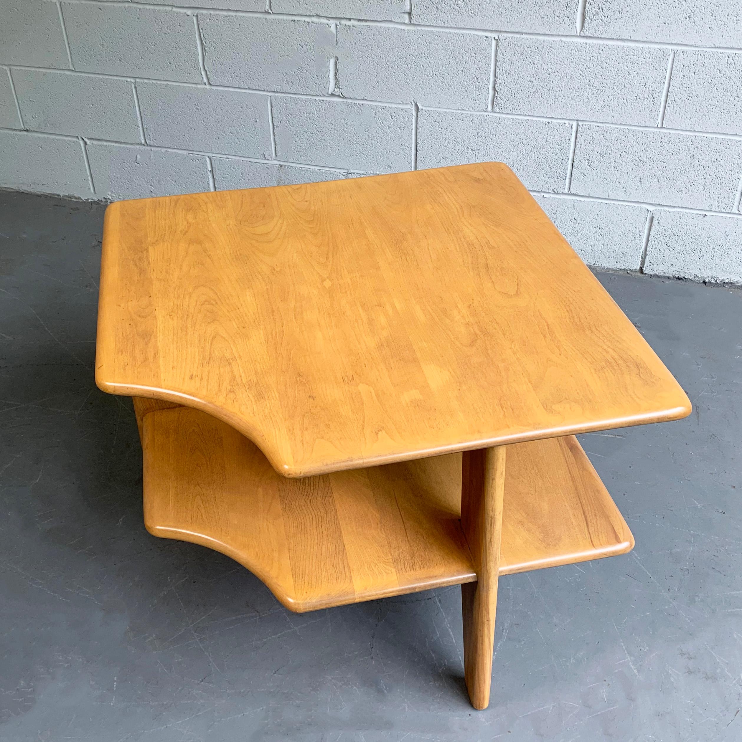 Sculptural, Mid-Century Modern, tiered maple, corner side table by Russel Wright for Conant ball features a carved edge to create a corner in between sofas or chairs. The bottom tier is 12 inches height.