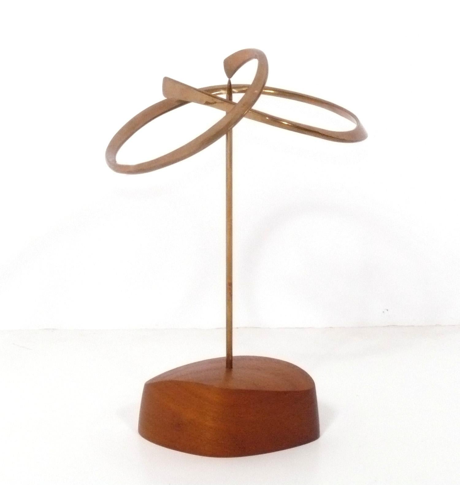 Mid-Century Modernist Bronze and Teak Sculpture by Russell Secrest, American, circa 1970s. Russell Secrest (1935-2010) is known for both his sculptures and modernist jewelry designs. Born in Muncie, Indiana, Secrest earned an Associates in Applied