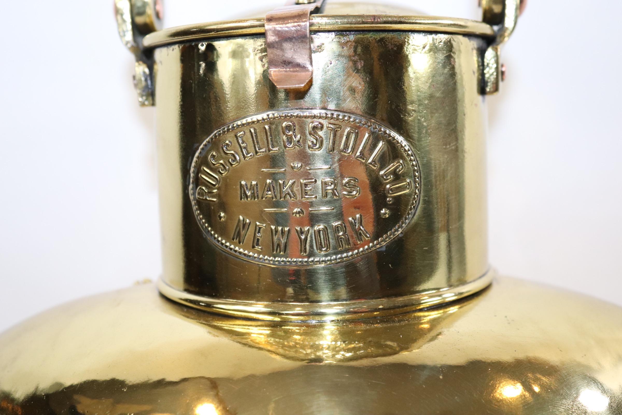 Highly polished and lacquered ships port lantern with brass makers badge with makers name 