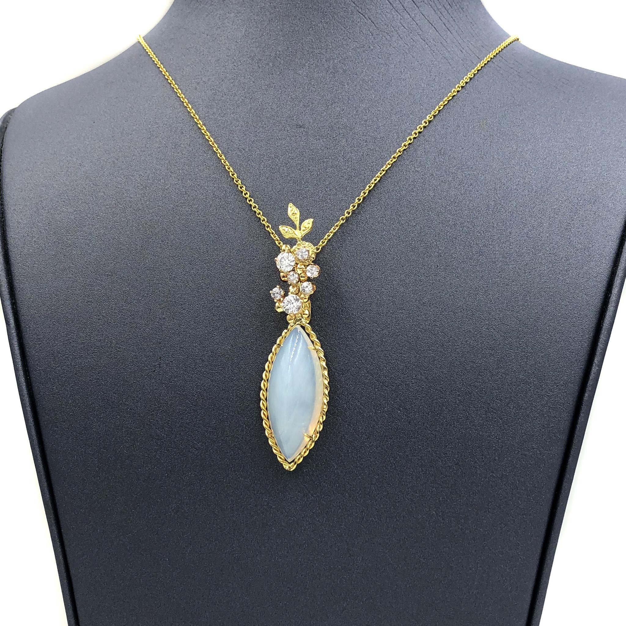 One of a Kind Necklace by acclaimed jewelry maker Russell Trusso featuring a spectacular milky marquise chalcedony cabochon with a subtle yellow-orange glows. The gem is wrapped in a handmade 18k yellow gold setting and sits beneath seven shimmering