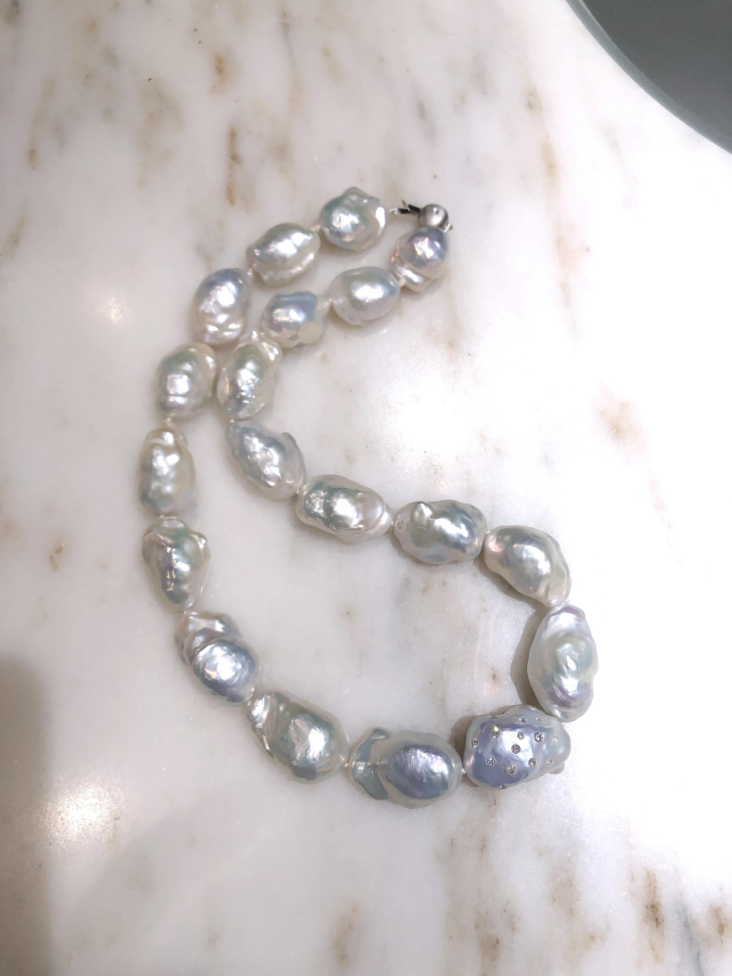 One of a Kind Pearl Necklace by acclaimed jewelry artist Russell Trusso featuring a iridescent strand of stunning white freshwater pearls, embellished with one of the designer's signature diamond-embedded pearls, set on each side with a total of