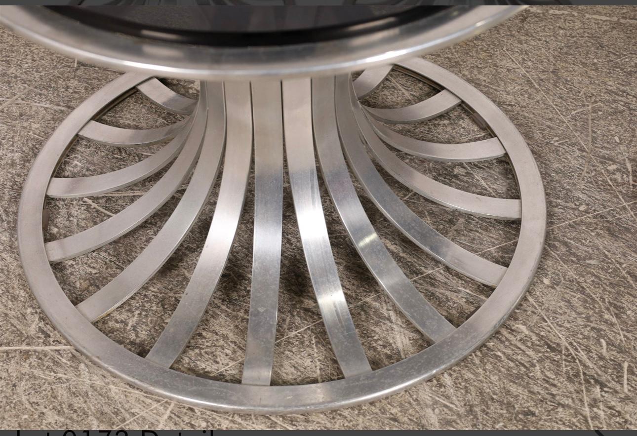 An elegant pair of Russell Woodard Aluminum patio tables. They feature smoked glass tops and flaring base, like the rest of the aluminum line he designed. Please have a look at the chaise lounge we have listed on this site as well. The aluminum has
