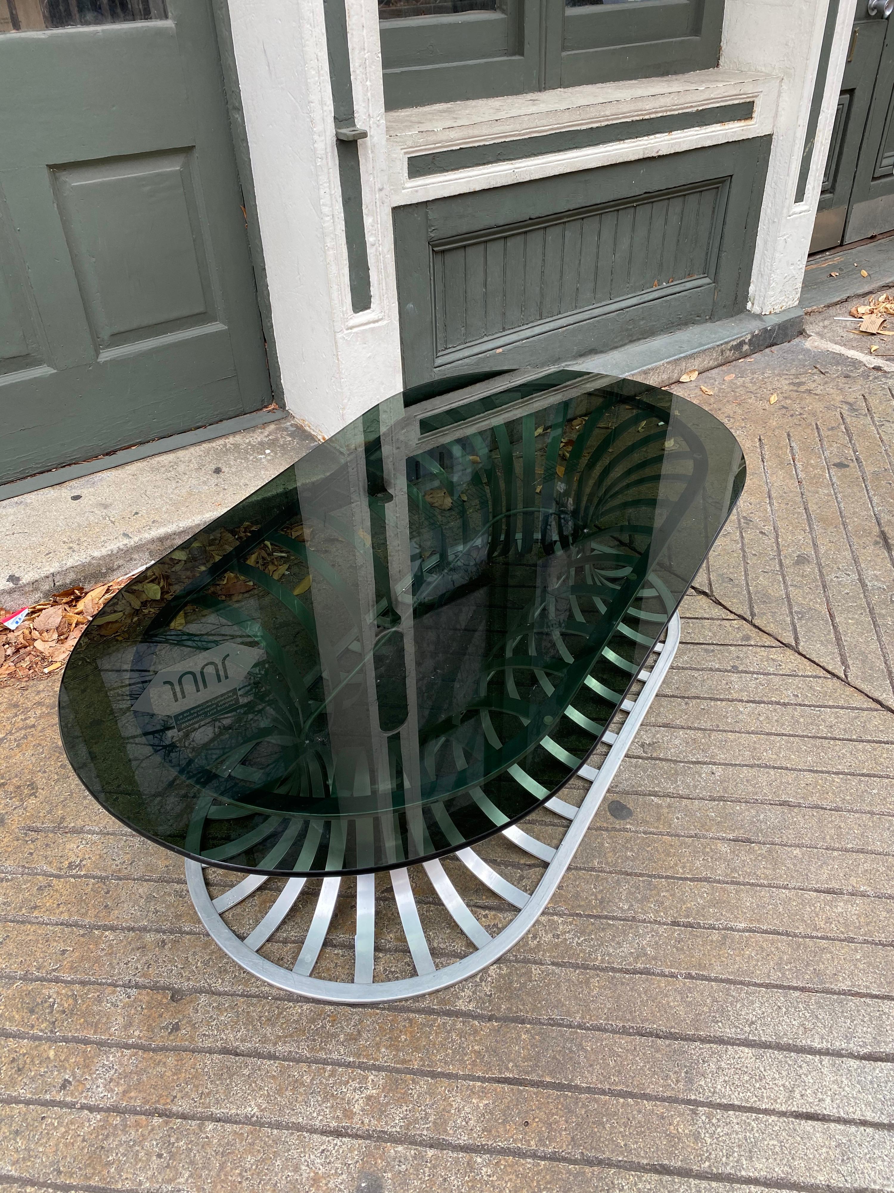Russell Woodard aluminum coffee table with oval smoked glass top. Very clean example, side and end tables are the hardest of the series to find!