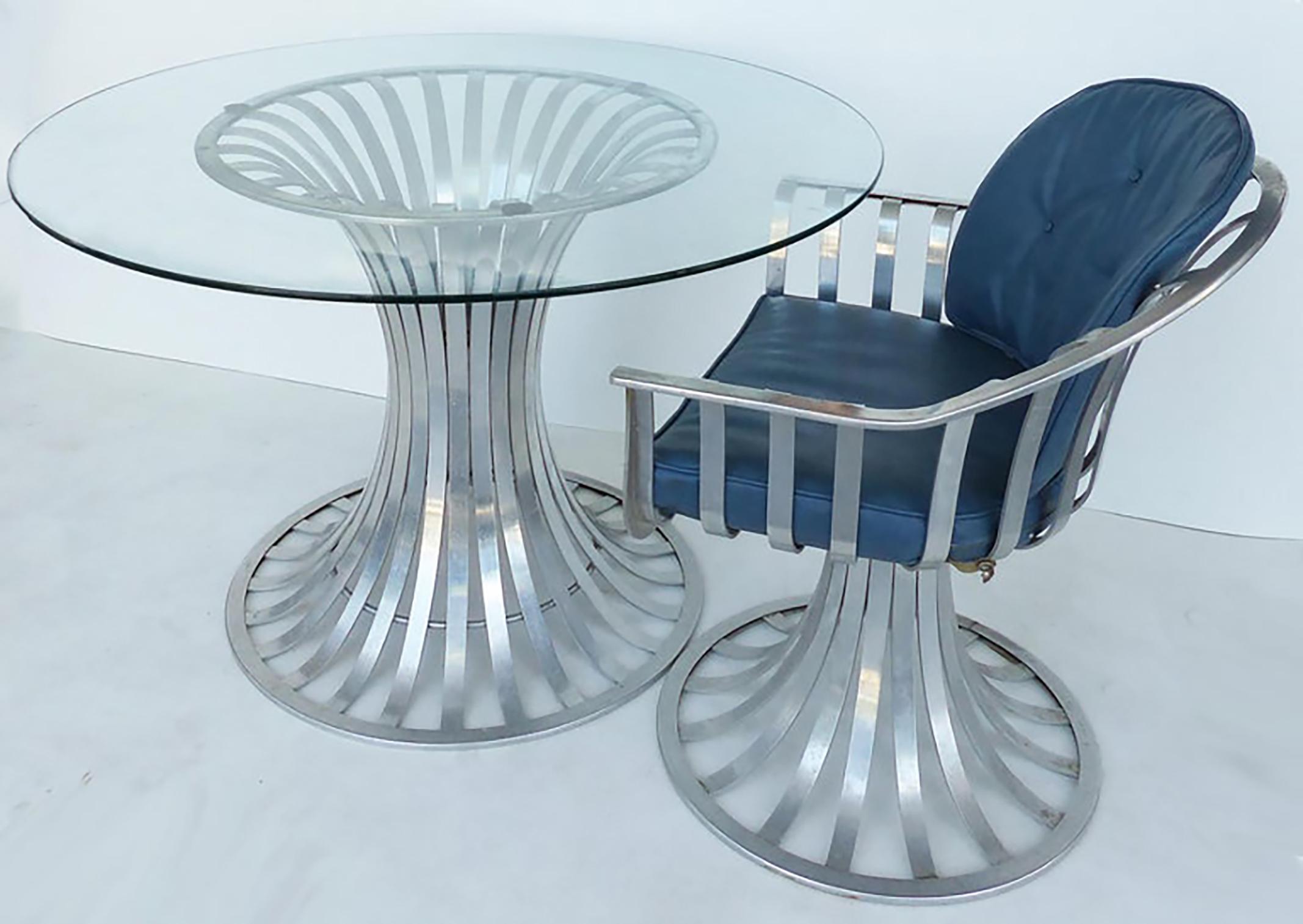 Russell Woodard aluminum mid-century table 4 chairs and cushions

Offered for sale is an iconic Russell Woodard mid-century aluminum table with a glass top and 4 matching chairs. The chairs are complete with their fitted cushions.

Table: Height