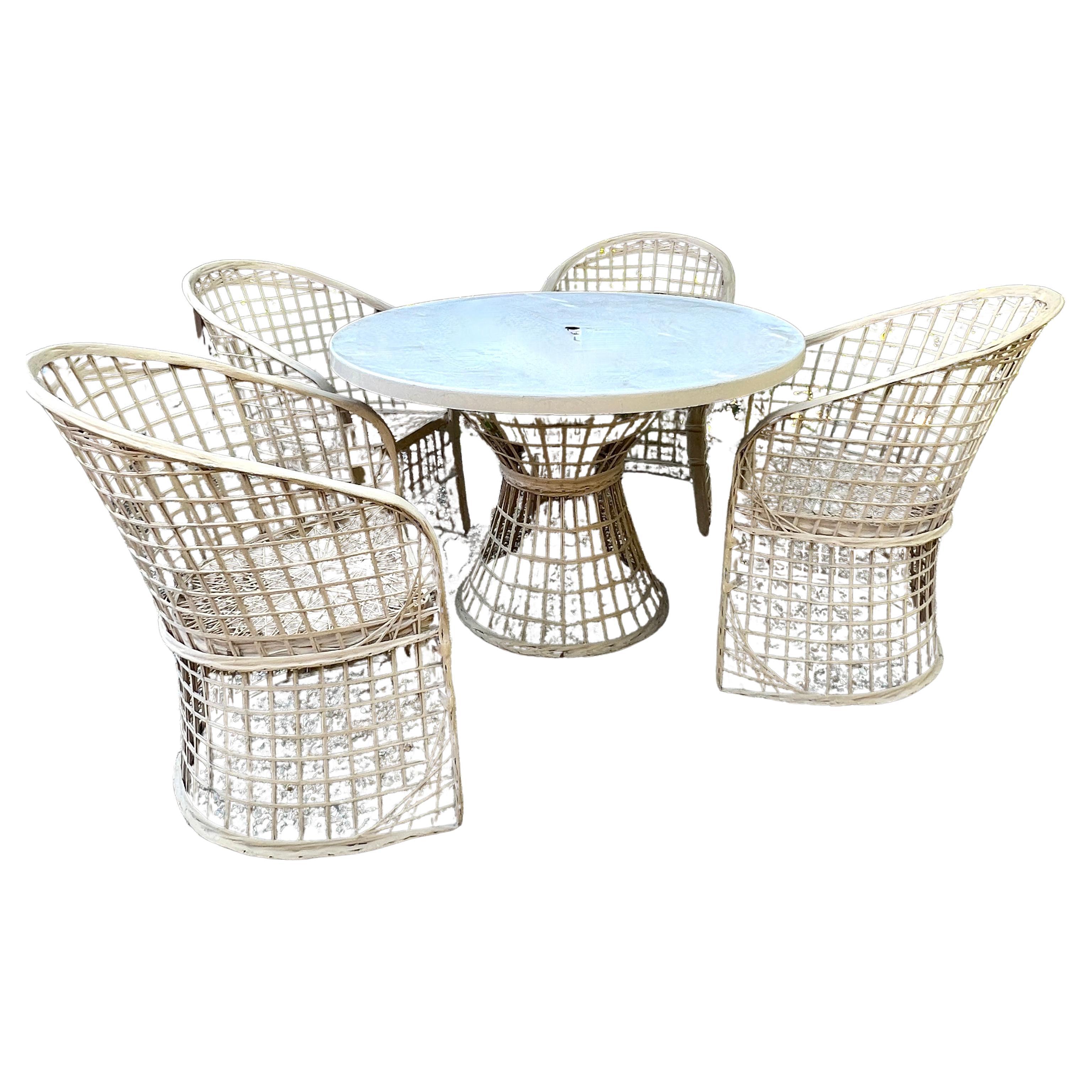 Russell Woodard Dining Set of Spun Fiberglass.  The set consists of four chairs, the coordinating spun fiberglass base and a fiberglass top with a hole for Umbrella.  As an Alternative the fiber glasstop could be substituted for a thick piece of