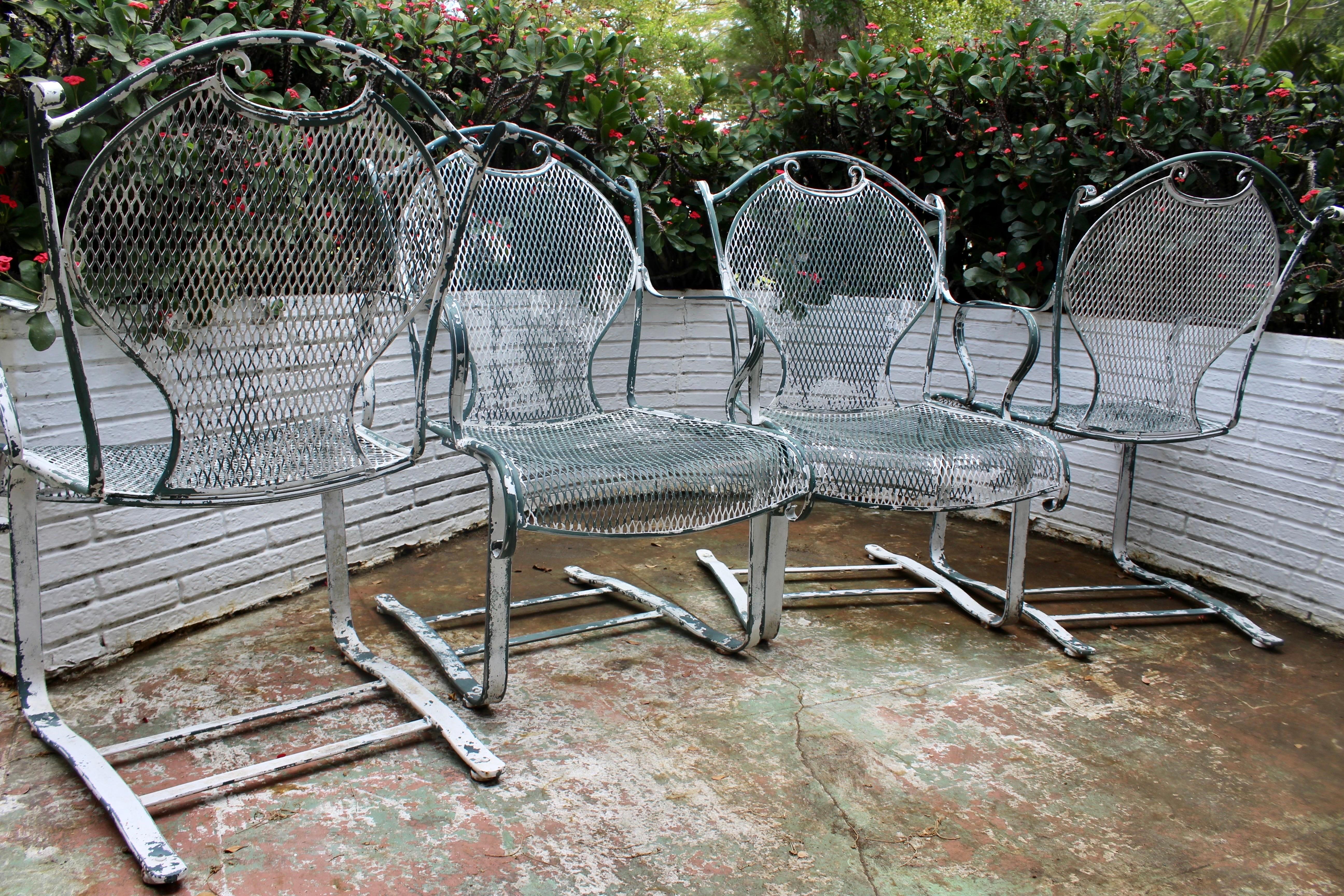 Large well made vintage Midcentury Modern Wrought Iron Mesh Bouncy Rocking Arm Chairs Set of 4. Styled after Russell Woodward. Original Florida green paint can be restored for a more modern look or retained for a true vintage feel. High back