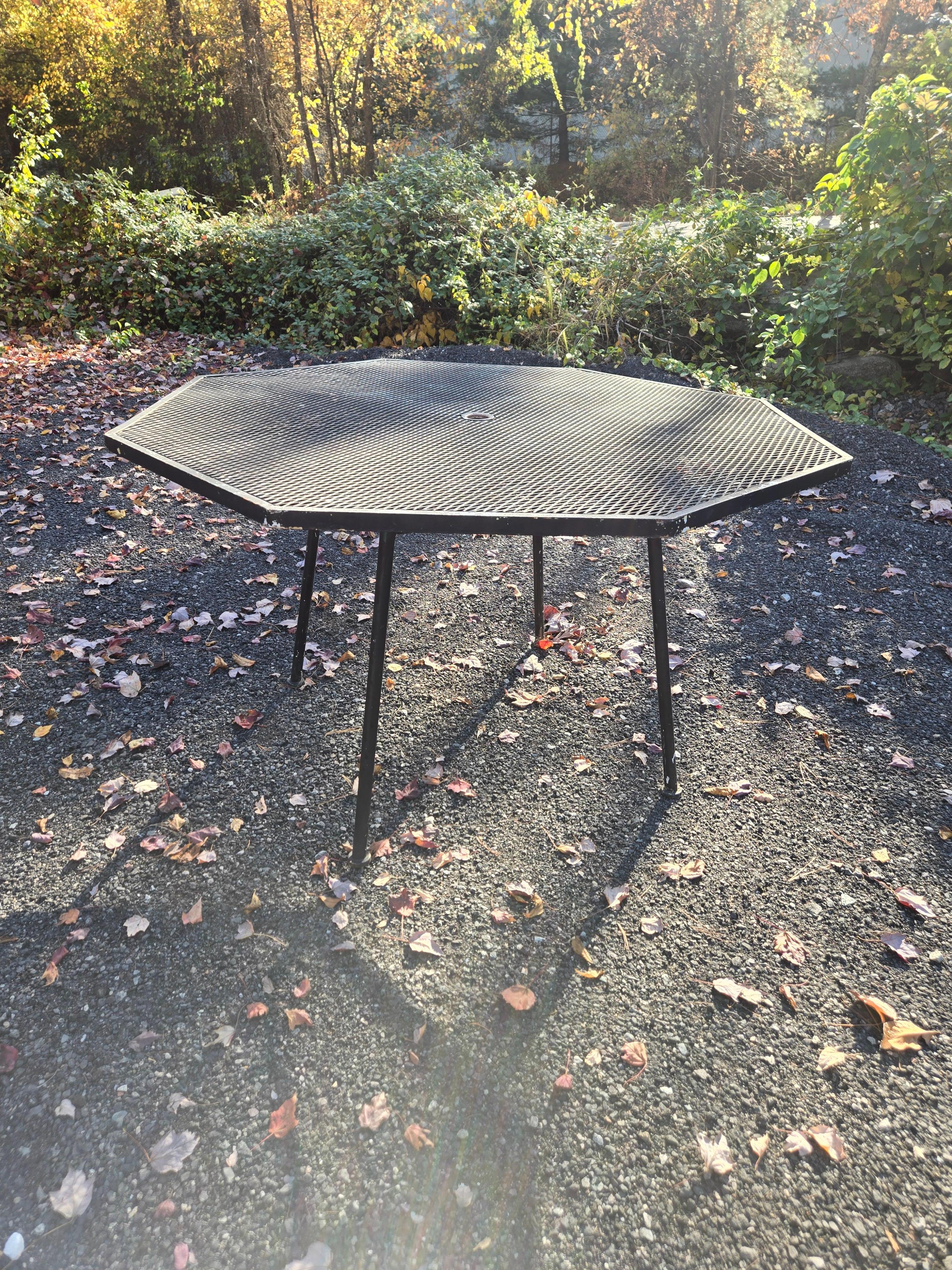 This is a Vintage Wrought Iron Octagonal Table by Russell Woodard. It pairs perfectly with out set of 6 Sculptura Chairs. This table is made of heavy duty wrought iron and an excellent choice for any deck, garden, patio, or poolside. 

Refinishing