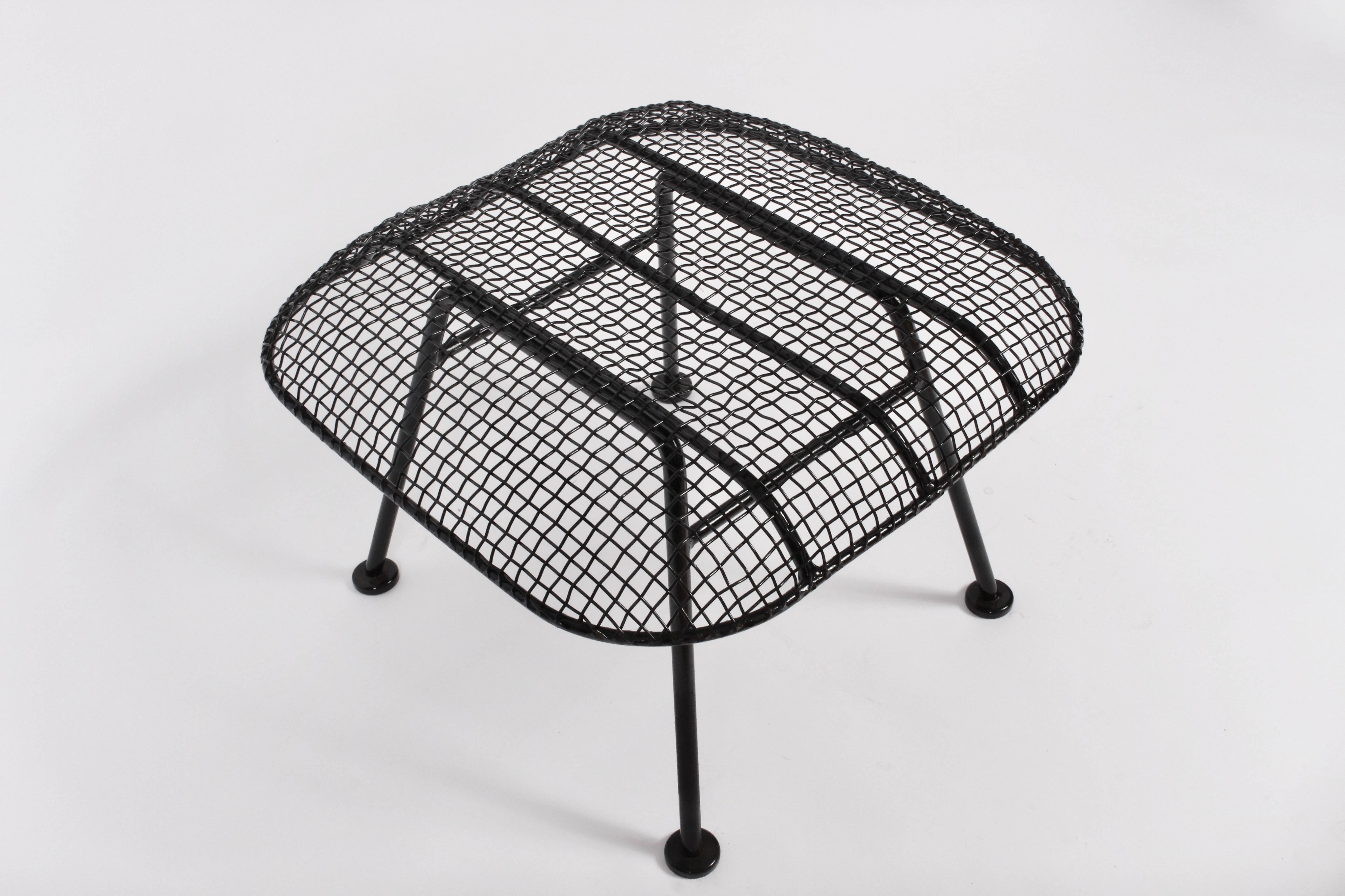 Larger American Mid-Century Modern Russell Woodard black wrought iron and black mesh stool. Corner to corner measurements: 25 W. Relaxed. Comfortable. Indoor outdoor seating. Professionally sandblasted and painted in high gloss black enamel paint.