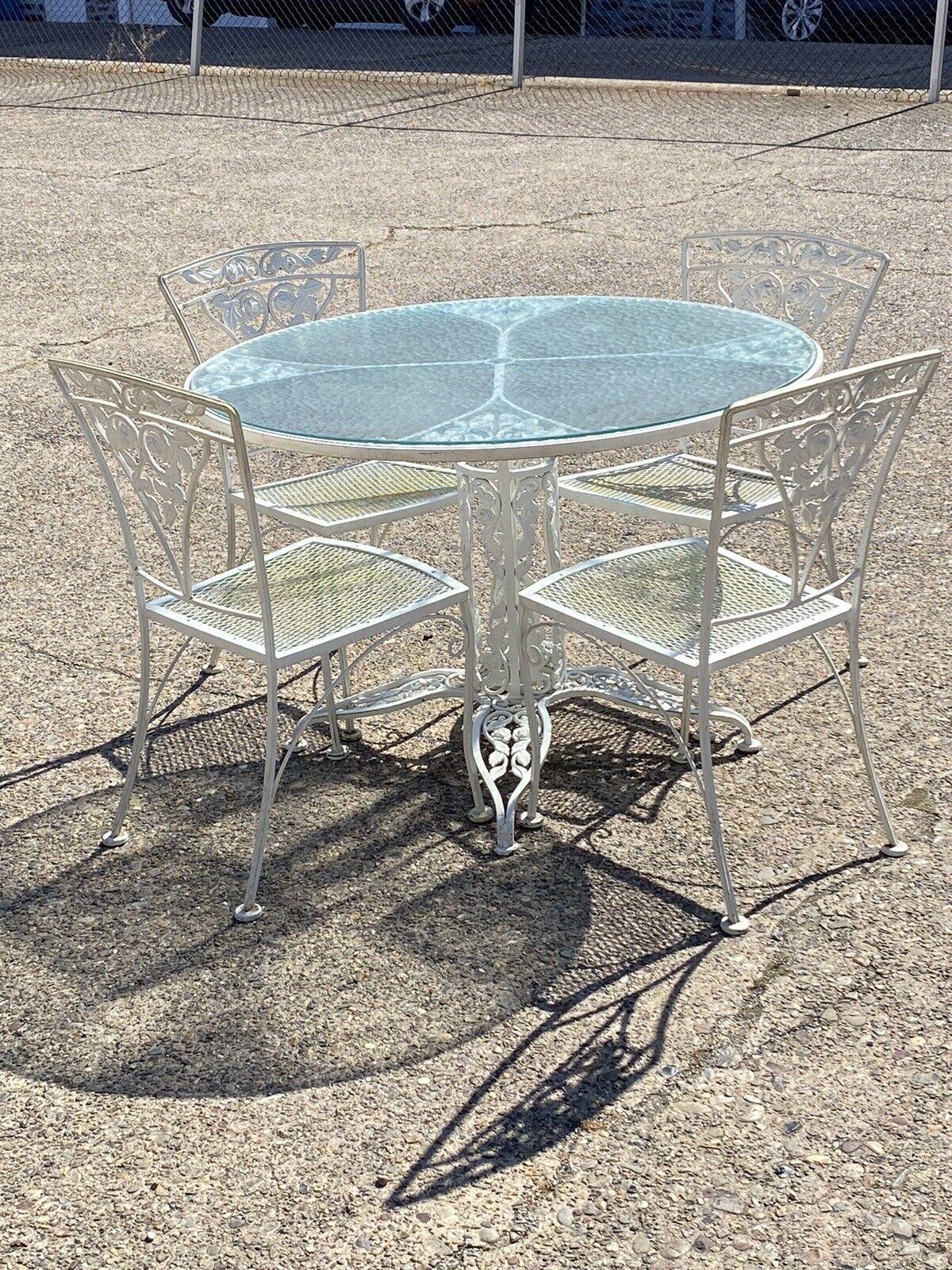Russell Woodard Orleans Pattern Wrought Iron Patio Garden Dining Set - 5 Pc Set. Item features a very rare ornate pedestal base round dining table with glass top, Wrought iron frames, (4) dining chairs, very nice vintage set, quality American