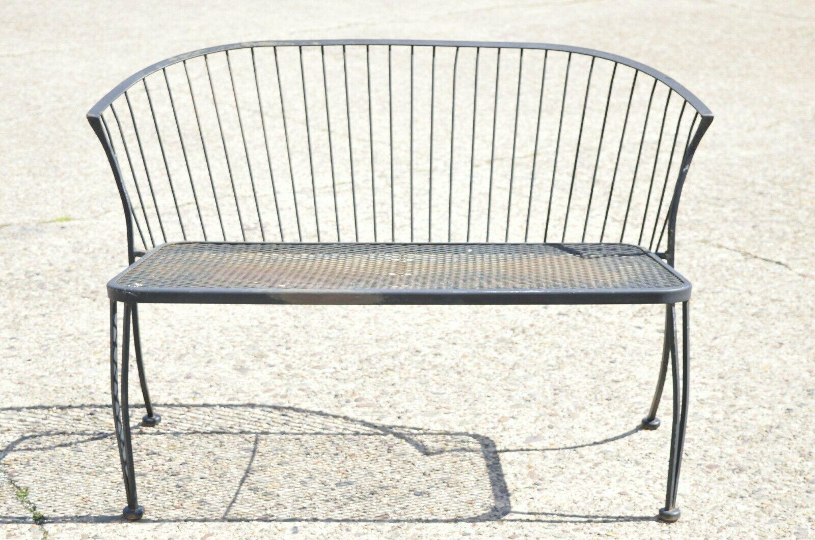 Russell woodard pinecrest style black wrought iron garden patio loveseat settee. Item features curved barrel back, mesh seat and back, wrought iron construction, clean modernist lines, sleek sculptural form, unmarked, possibly by Russell Woodard.