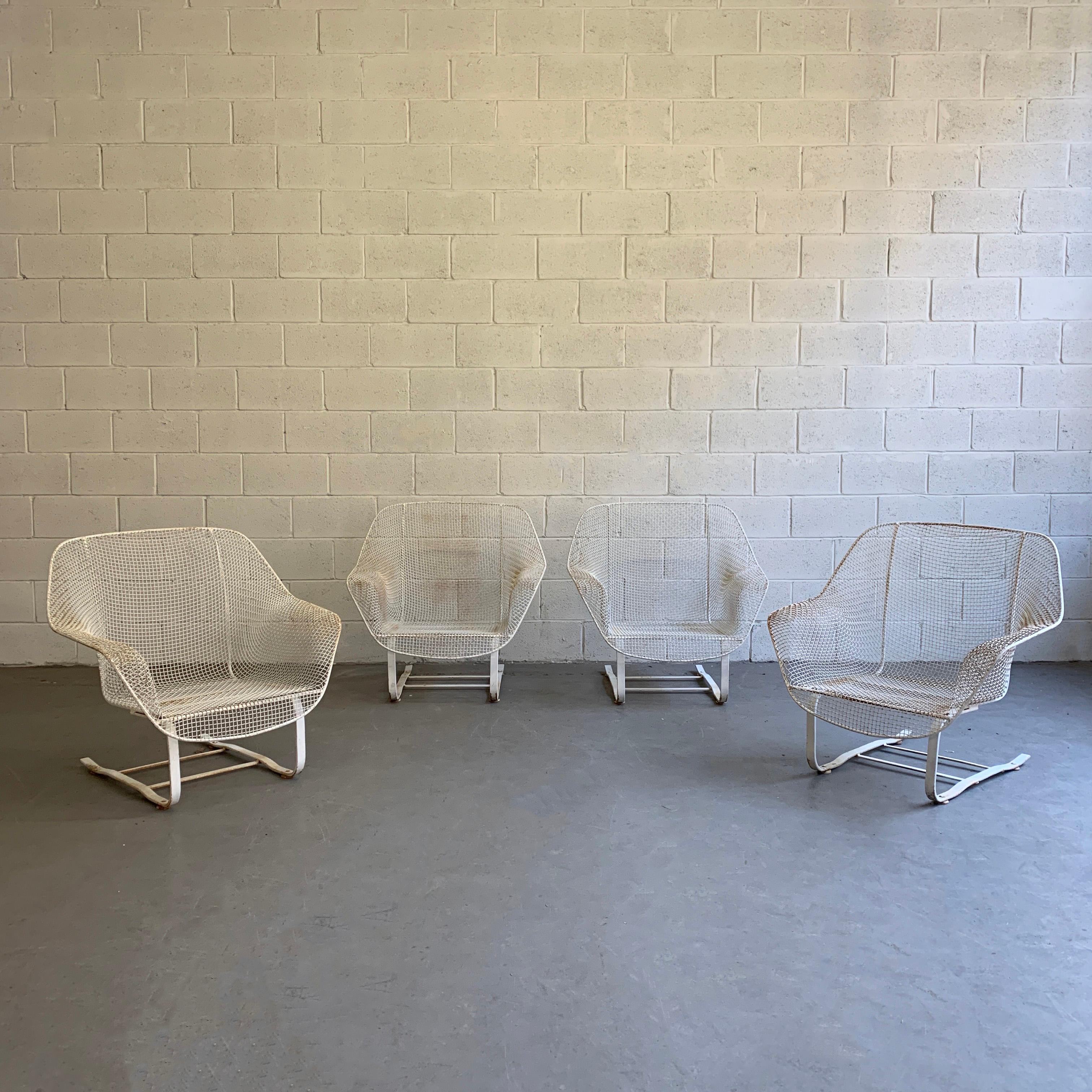 Pair of Mid-Century Modern, outdoor, patio lounge chairs by Russell Woodard, Sculptura feature low, wide wrought iron mesh frames with cantilevered steel bases that gently bounce with original cushions. Sold as a pair, two pairs are available.