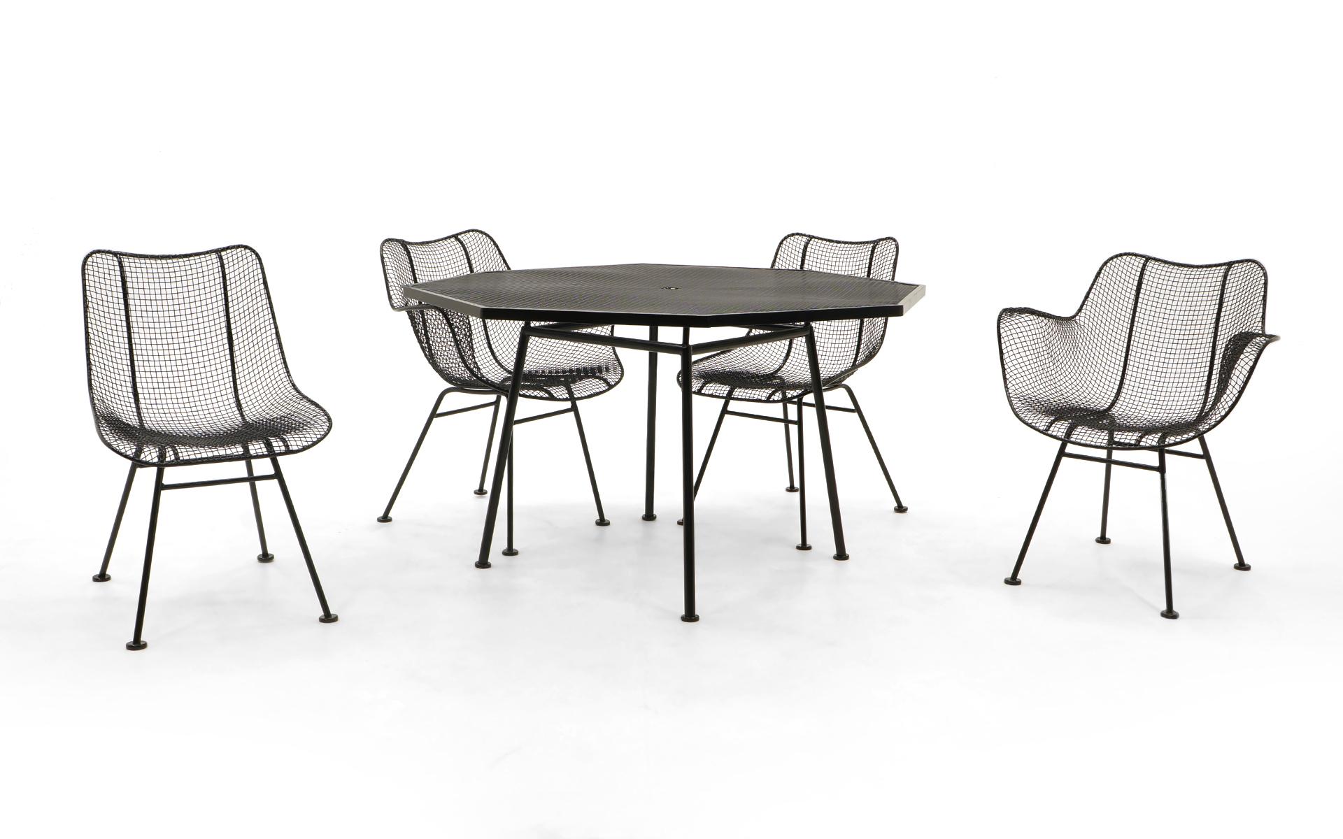 Octagonal Russell Woodard dining table with four woven wire sculptura dining chairs, two with arms, two armless. Professionally media blasted and powder coated in a satin black finish. Never outdoors since restoration.
Measurements:
Table: 28.5