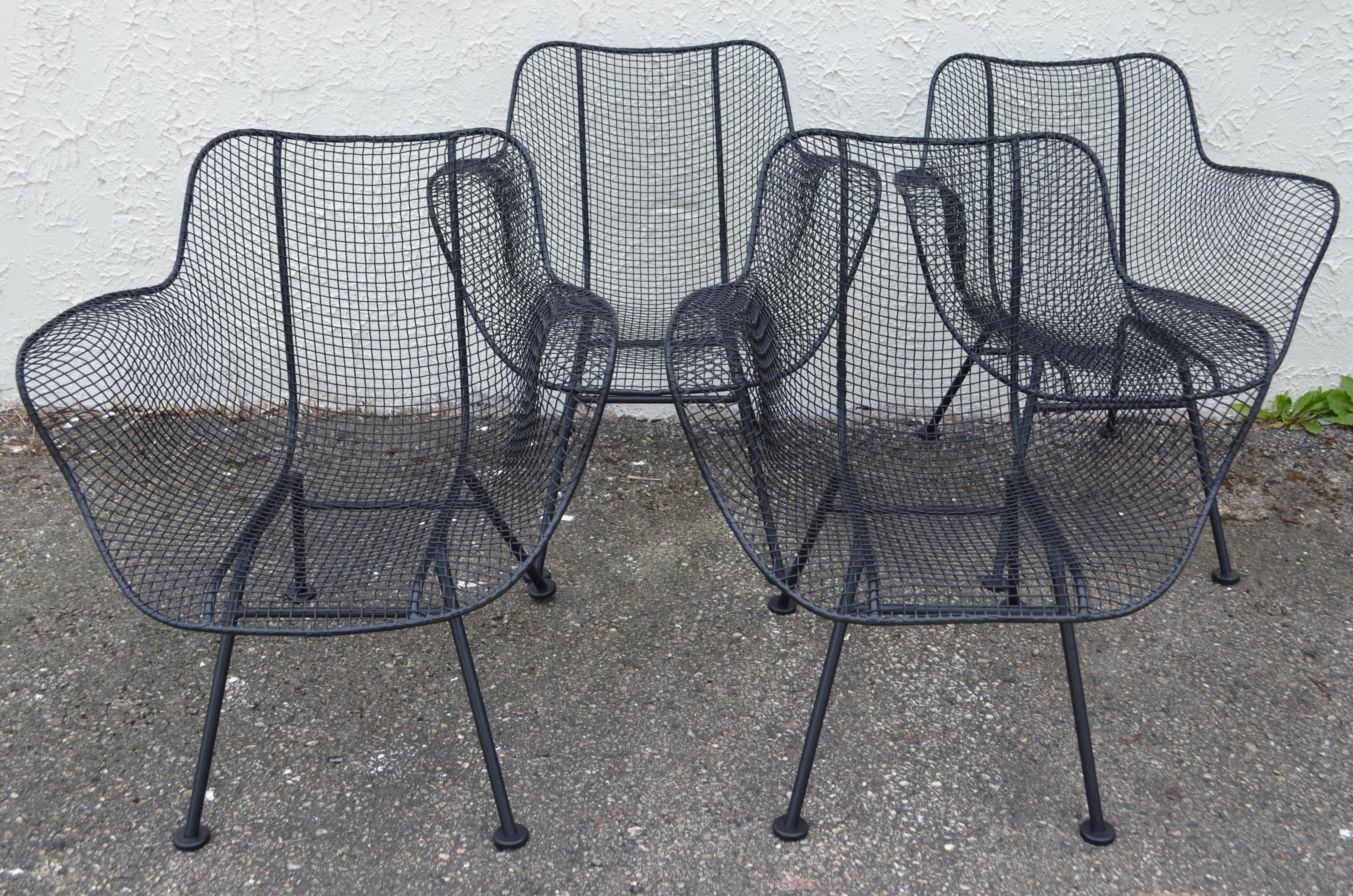 Designed by Russell Woodard in the 1950s, a set of 4 Classic sculptura patio chairs. Sculpted in a ergonomic form. Recently sanded and powder-coated to perfection in satin black. These chairs sit so comfortably and look so very cool stationed on a