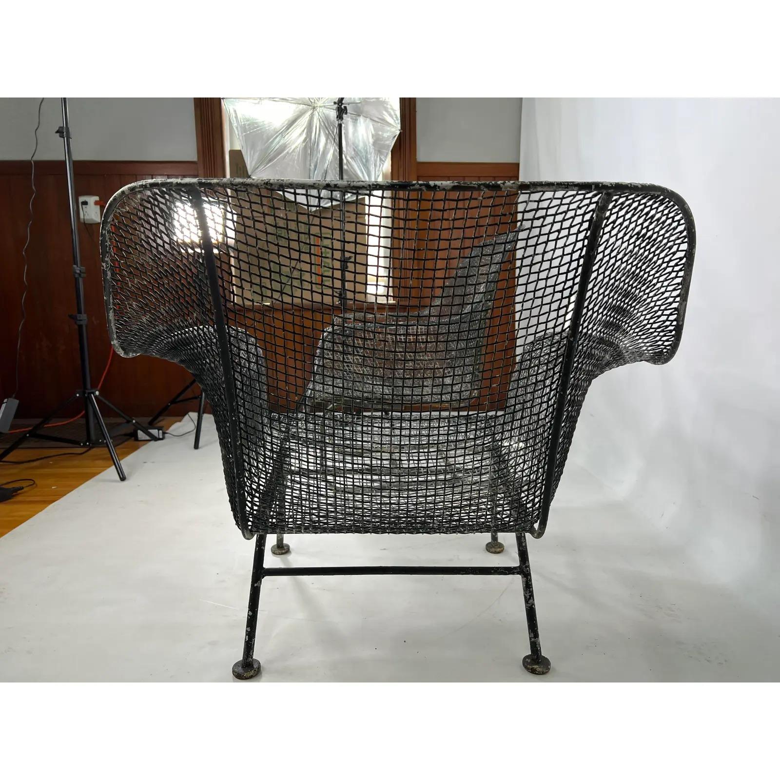 These Russell Woodard lounge chairs are made out of wrought iron with steel and mesh. Included in the set is a standard lounge chair and a spring chair. The measurements for the chair without spring are: 33” W 22” D 27.25” H.