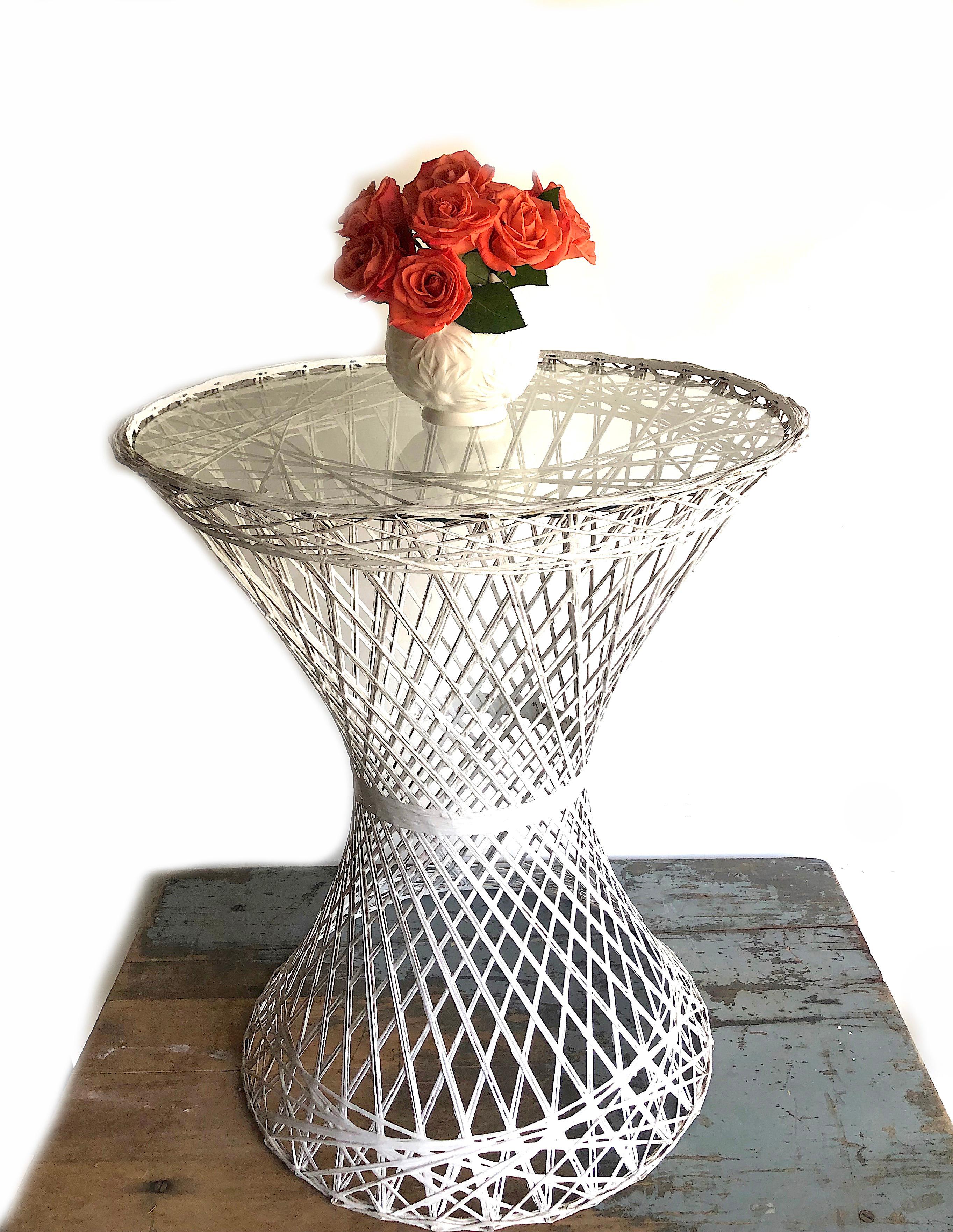 Side or bistro table by Russell Woodard for his family company's popular line of spun fiberglass patio furniture. The design features an hourglass shape and round pedestal base. The frame is an intricate lattice of fiberglass spokes with a white
