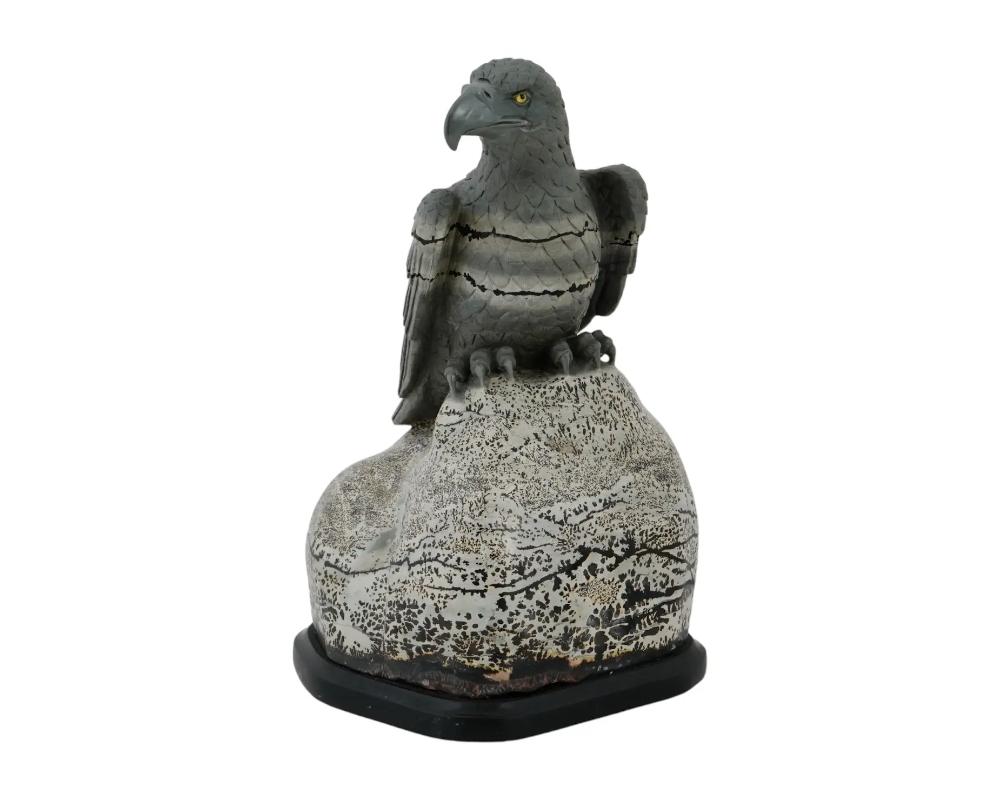 A russian hand carved Jasper stone sculpture, Eagle on Alert, The sculpture depicts an eagle sitting on a boulder, eyeing on its prey. This highly graphic variety of jasper, known as Natures Paintbrush. Mounted on a black Onyx base. Unmarked. Circa: