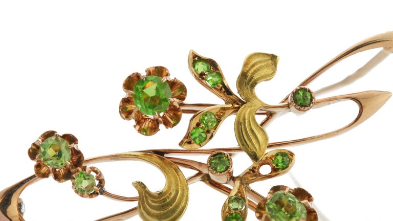 This is a breathtaking Russian brooch in 14k rose gold from 1890 featuring a stunning array of demantoid garnet in a delicate floral pattern
Maker: ИГ / IG (probably Ivan Gurjanov).
Made in Russia Circa 1890.
Marked with 56 zolotniks old Russian