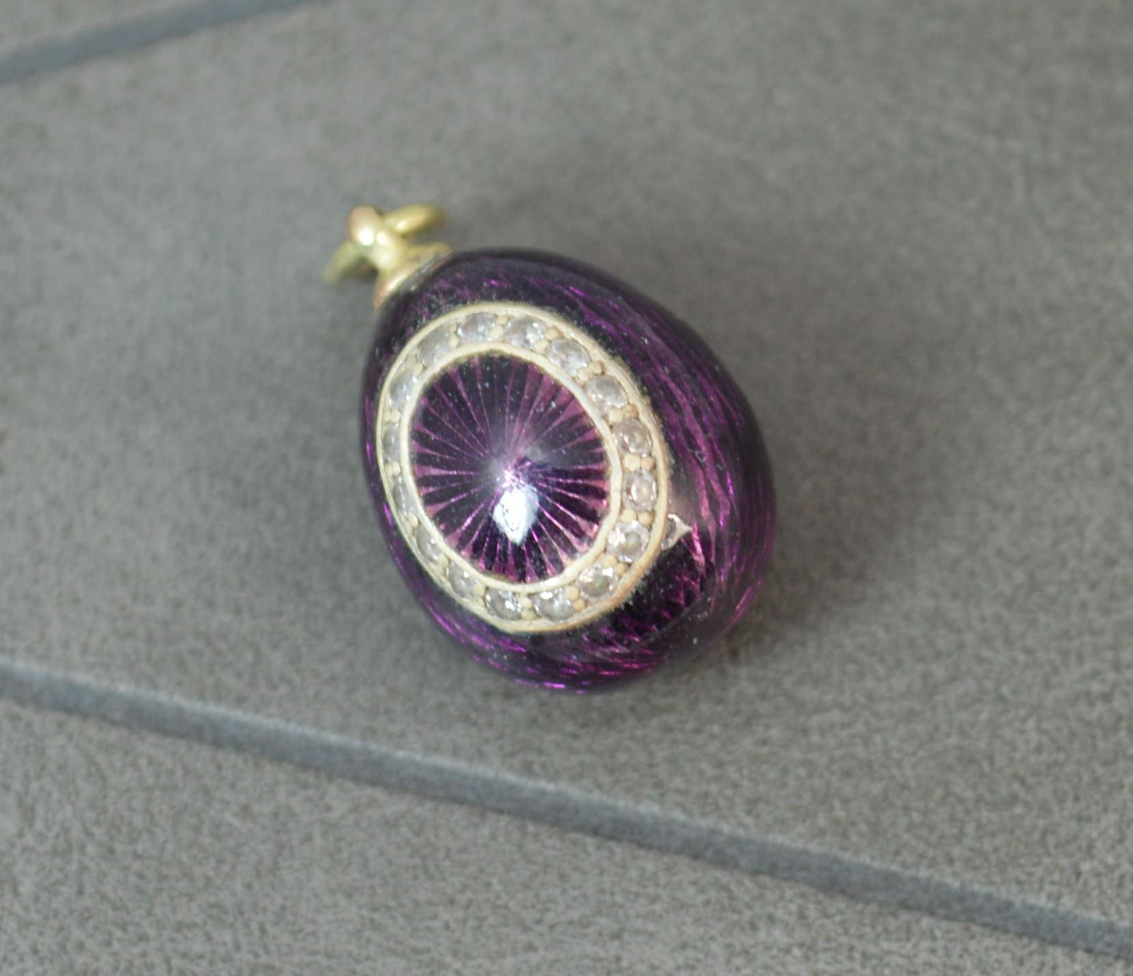 A stunning Russian egg charm pendant.
14 carat yellow gold top.
Deep rich purple enamelling.
Oval stone set design to one side. White round cut stones.

CONDITION ; Very good for age. Clean piece. Well set stones, light wear. Issue free. A beautiful
