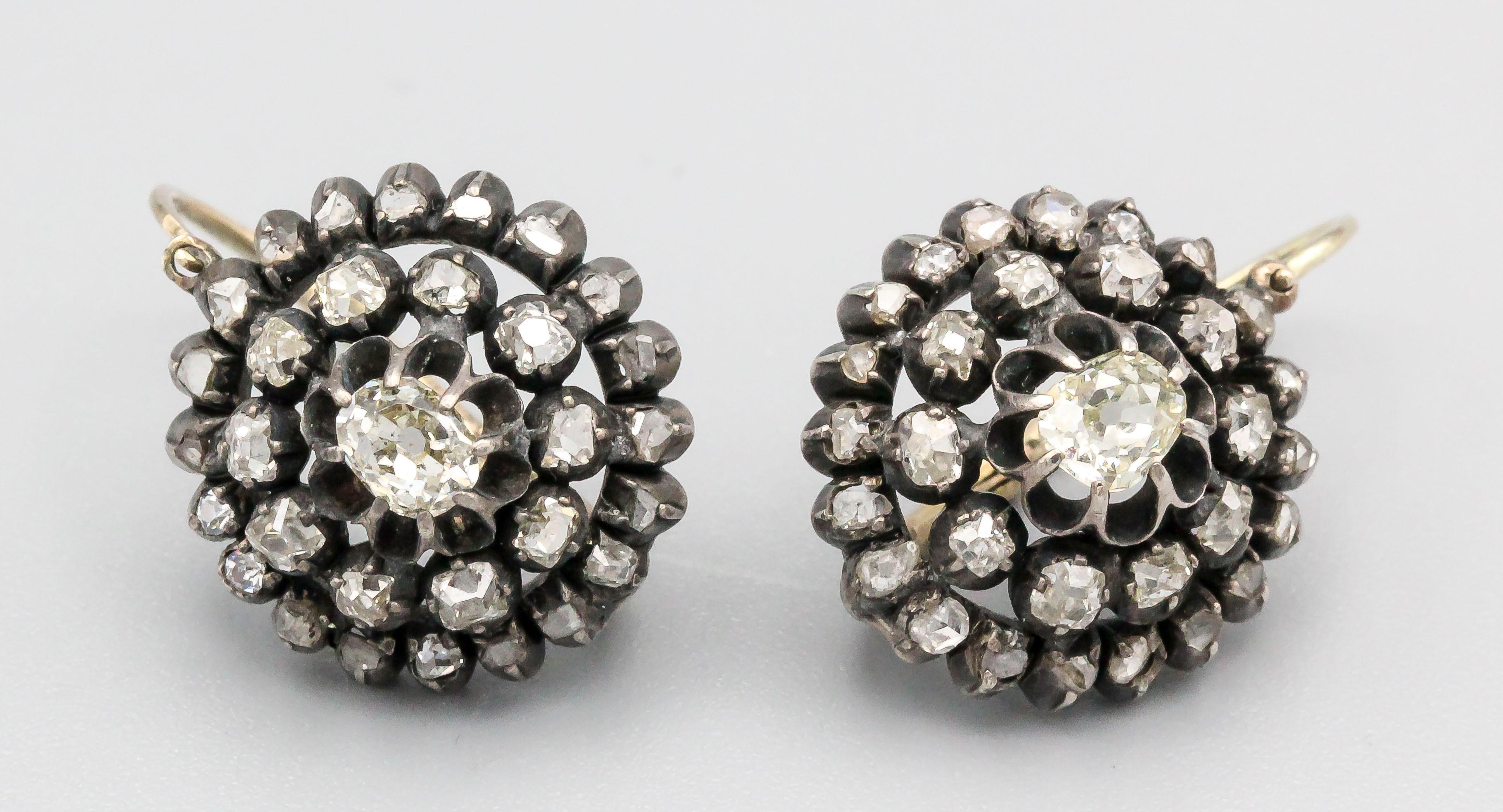 Elegant 19th century diamond, 14K yellow gold and silver earrings, circa 1850s. They feature diamonds over a silver setting with gold mounting tabs.

Hallmarks: Russian gold assay marks, makers marks (all faint)