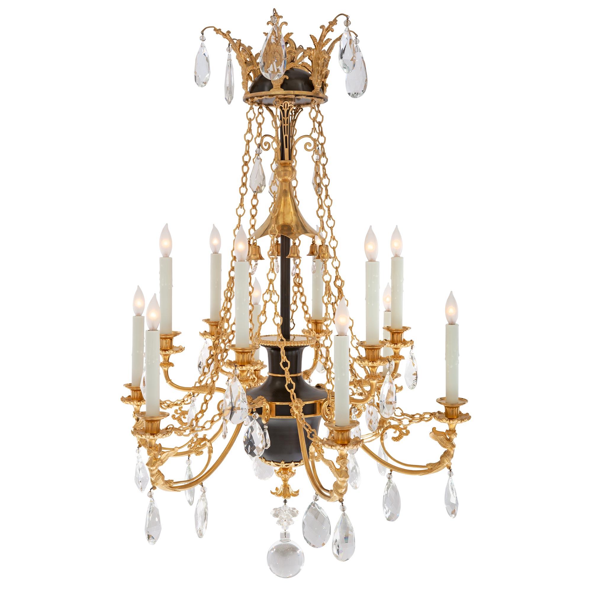 A sensational and extremely decorative Russian 19th century Empire st. patinated bronze, crystal, and ormolu chandelier. The twelve arm chandelier is centered by a Fine solid crystal ball below a richly chased inverted ormolu floral finial and