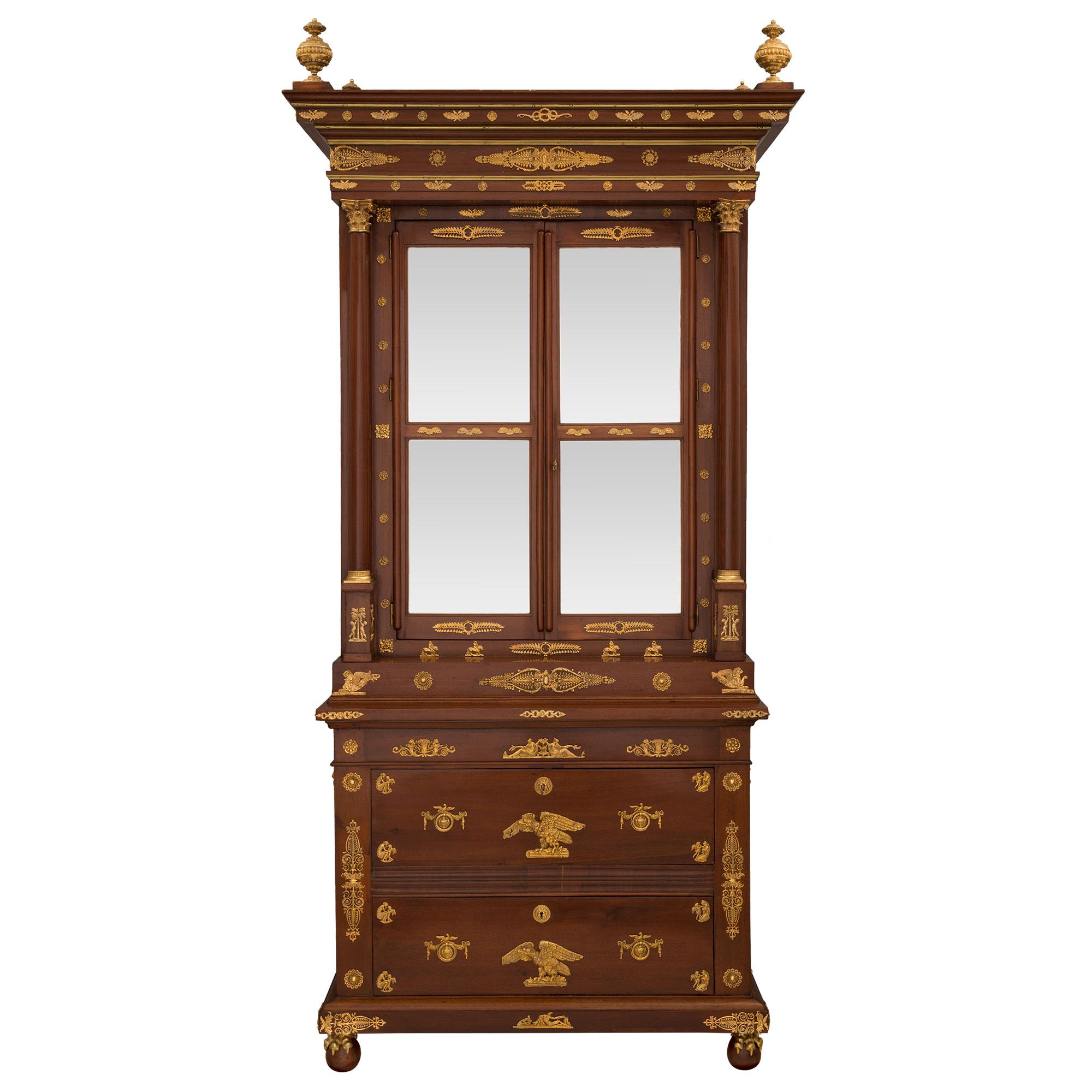 A most impressive and grand scale Russian 19th century Empire st. mahogany and ormolu Deux-Corps cabinet. The cabinet is raised by fine ball feet encased by handsome ormolu claws. Above each foot are intricately detailed pierced scrolled and