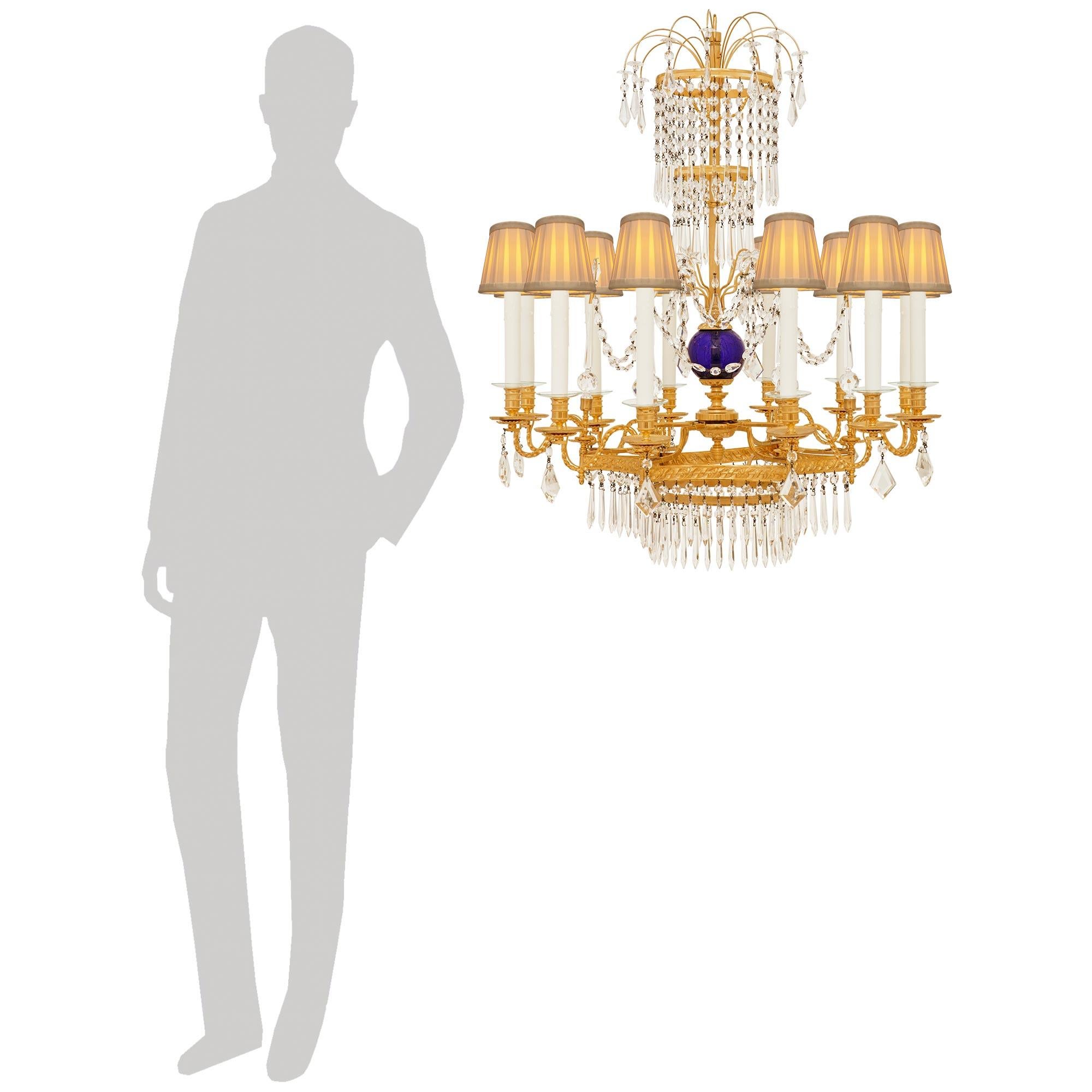 An exquisite and high quality Russian 19th century Neo-Classical st. Ormolu, Glass and Crystal chandelier. This spectacular circular chandelier is centered at the bottom by hexagonal tier with concave sides and displaying an intricate rope twist