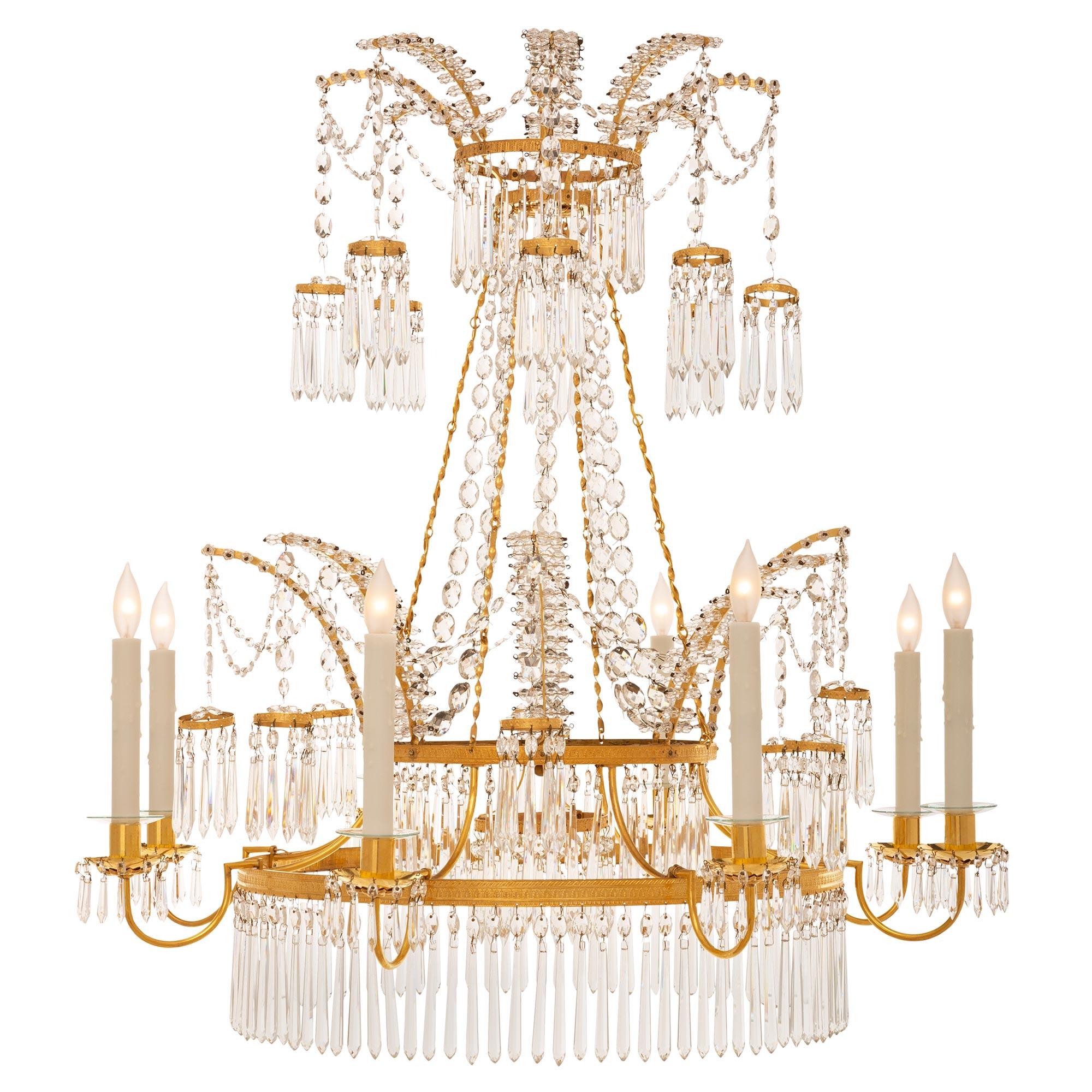 A stunning and extremely elegant Russian 19th century Neo-Classical st. ormolu, crystal, glass, and mirror chandelier. The eight arm chandelier displays a striking circular wrap around row of lovely prism shaped crystal pendants also repeated at the