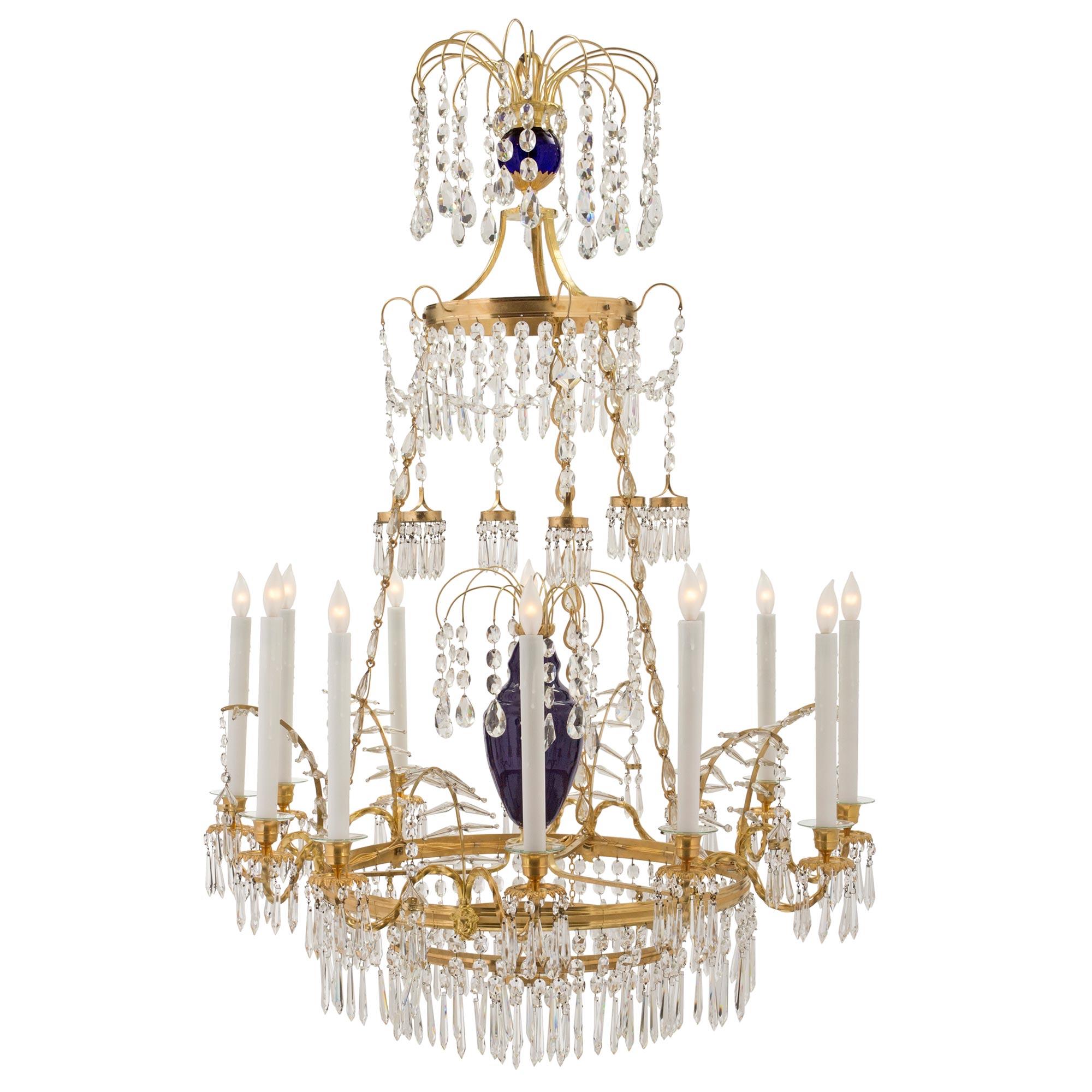 A magnificent Russian 19th century Neo-Classical st. cobalt blue glass, crystal, and ormolu twelve light chandelier. The chandelier is centered by a fine bottom circular pendant with elegant prism-shaped cut crystals. At the center is the striking