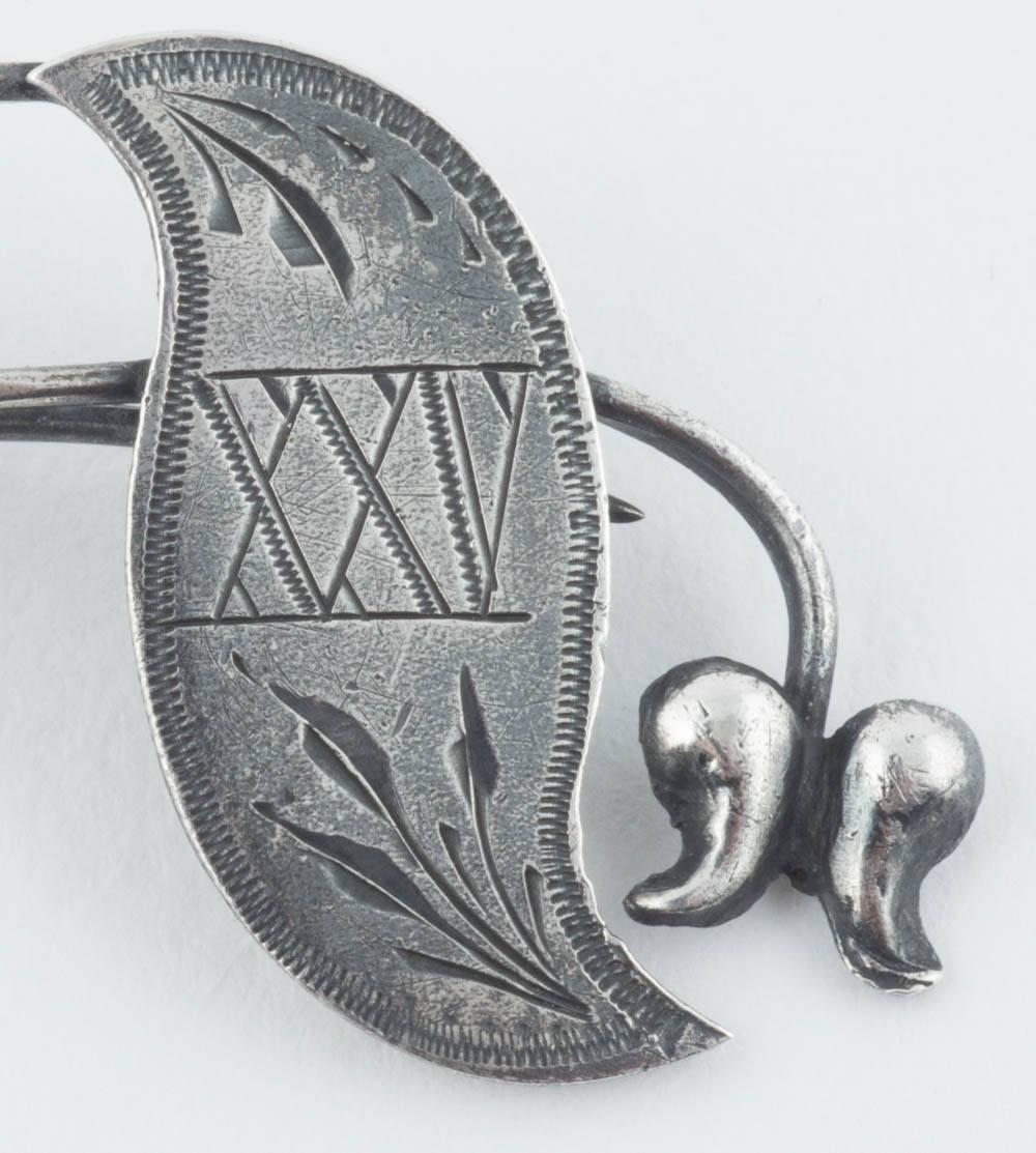 From the Romanov era, a whimsical pin engraved XXV with foliage in the Art Nouveau taste. 

Maker’s mark BK, 1908-1917, fully hallmarked. 

2 in. (5.1 cm.) long.

