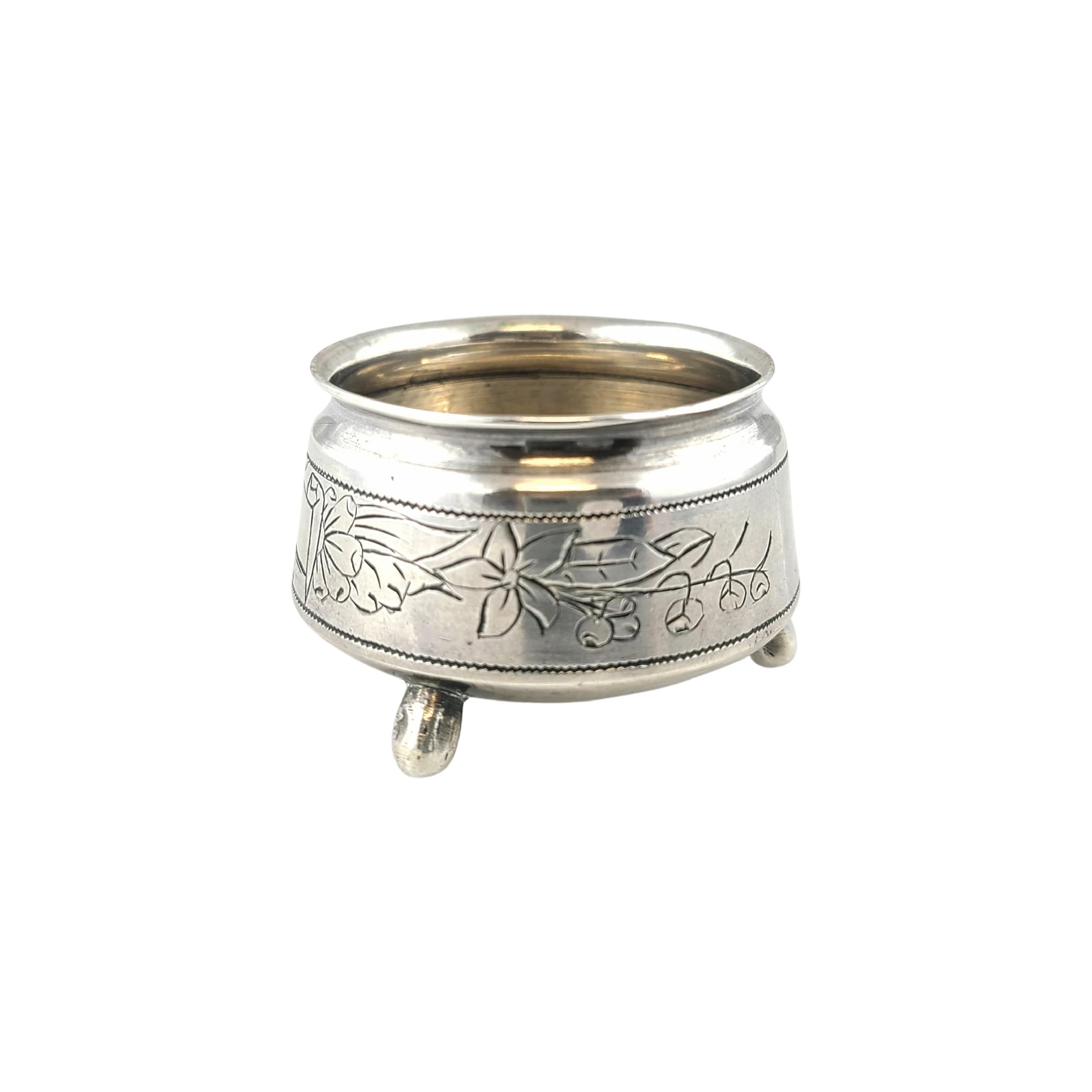 Russian silver salt cellar, .875 fineness.

This footed salt cellar features a beautiful bright cut etched blank ribbon and floral design.

Measures 1