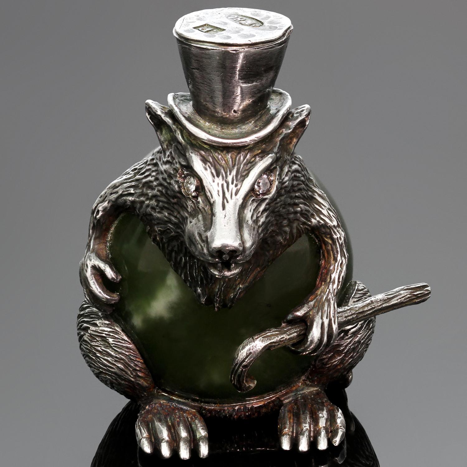 This exquisite Russian Imperial sculpture features a rat in a top hat with a movable cane crafted out of sterling silver and nephrite. The nephrite is medium to medium light muddy green with black inclusions, several white spots, and good luster.