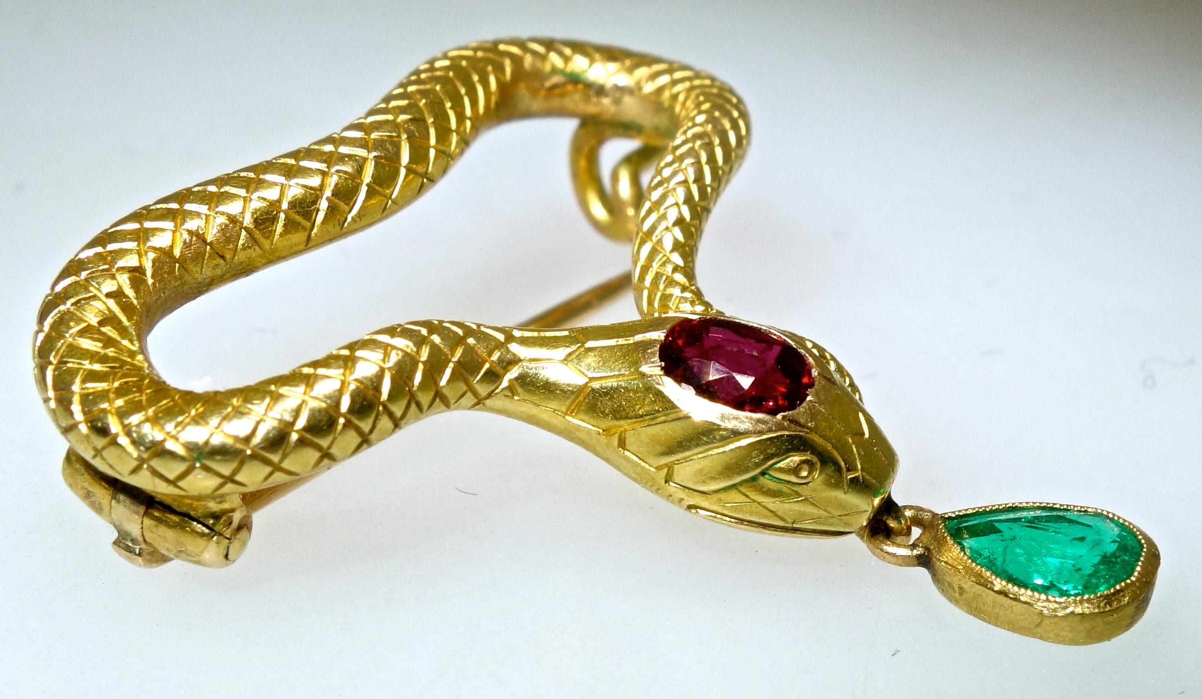 Faberge gold, ruby and emerald serpent brooch, the authentic marks on the verso for K. Faberge, Moscow, and 56 for the gold mark.  This serpent has a Colombian pear cut emerald suspended from his mouth, weighing approximately .33 cts., and a Burma