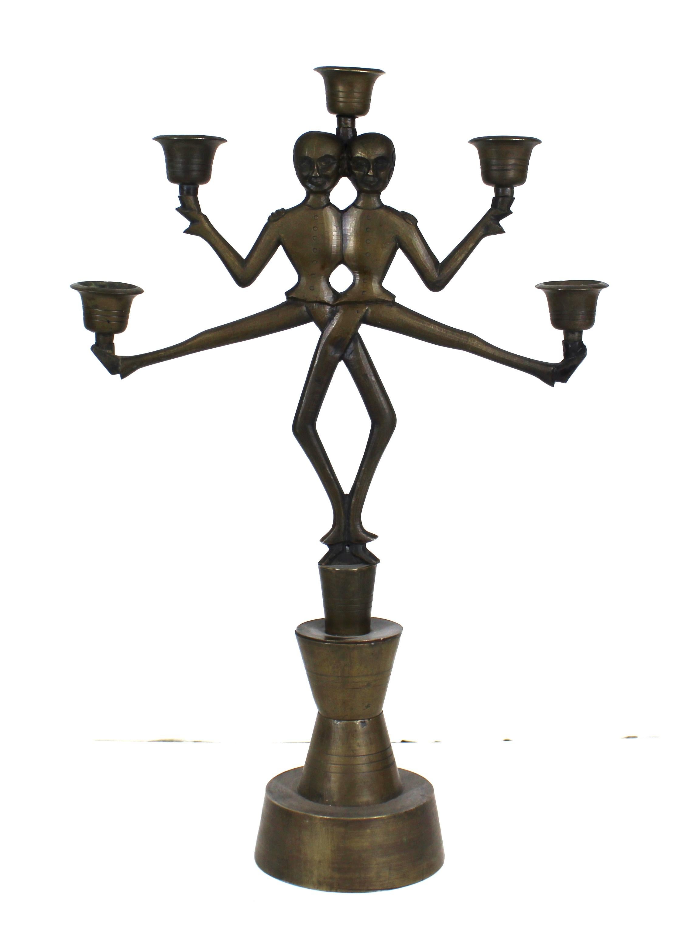 Russian Art Deco period pair of candelabras in heavy-cast bronze, featuring each a pair of dancing Cossack acrobats. The pair has their original and unaltered patina and was made during the 1920s in Russia. In great antique condition with