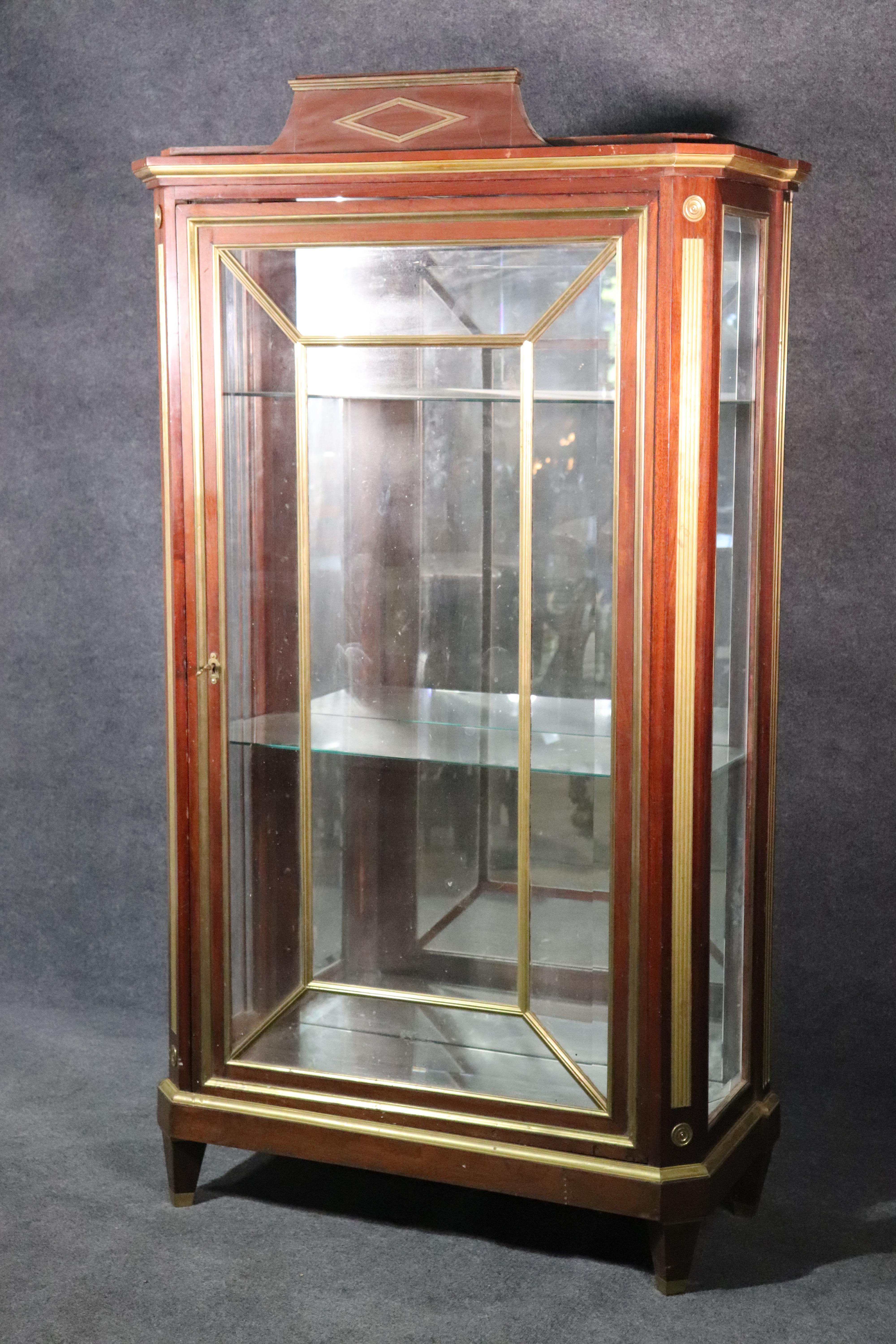This is a very unique Russian vitrine with fantastic bronze ormolu and directoire styling. Look at the gorgeous design and solid mahogany contrasting beautifully with the brass and bronze trim. Dates to the 1850s era and is extremely