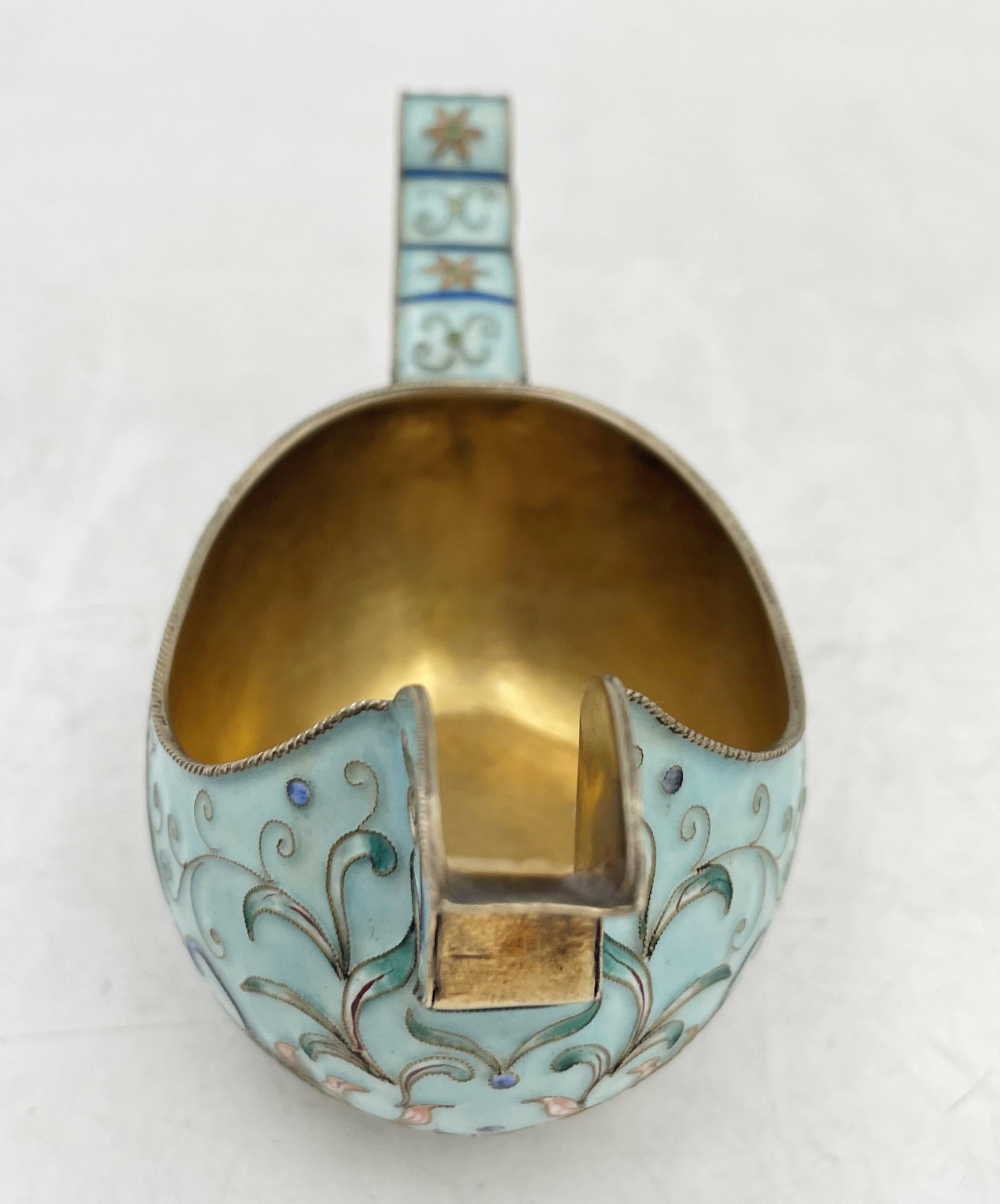 Russian, cloisonne enamel on 0.84 silver kovsh in Faberge style, measuring 4 3/4'' in length by 2 1/8'' in depth by 2 1/2'' in height, weighing 3.3 troy ounces (102.6 grams), and bearing hallmarks as shown. 

We hand polish all items before