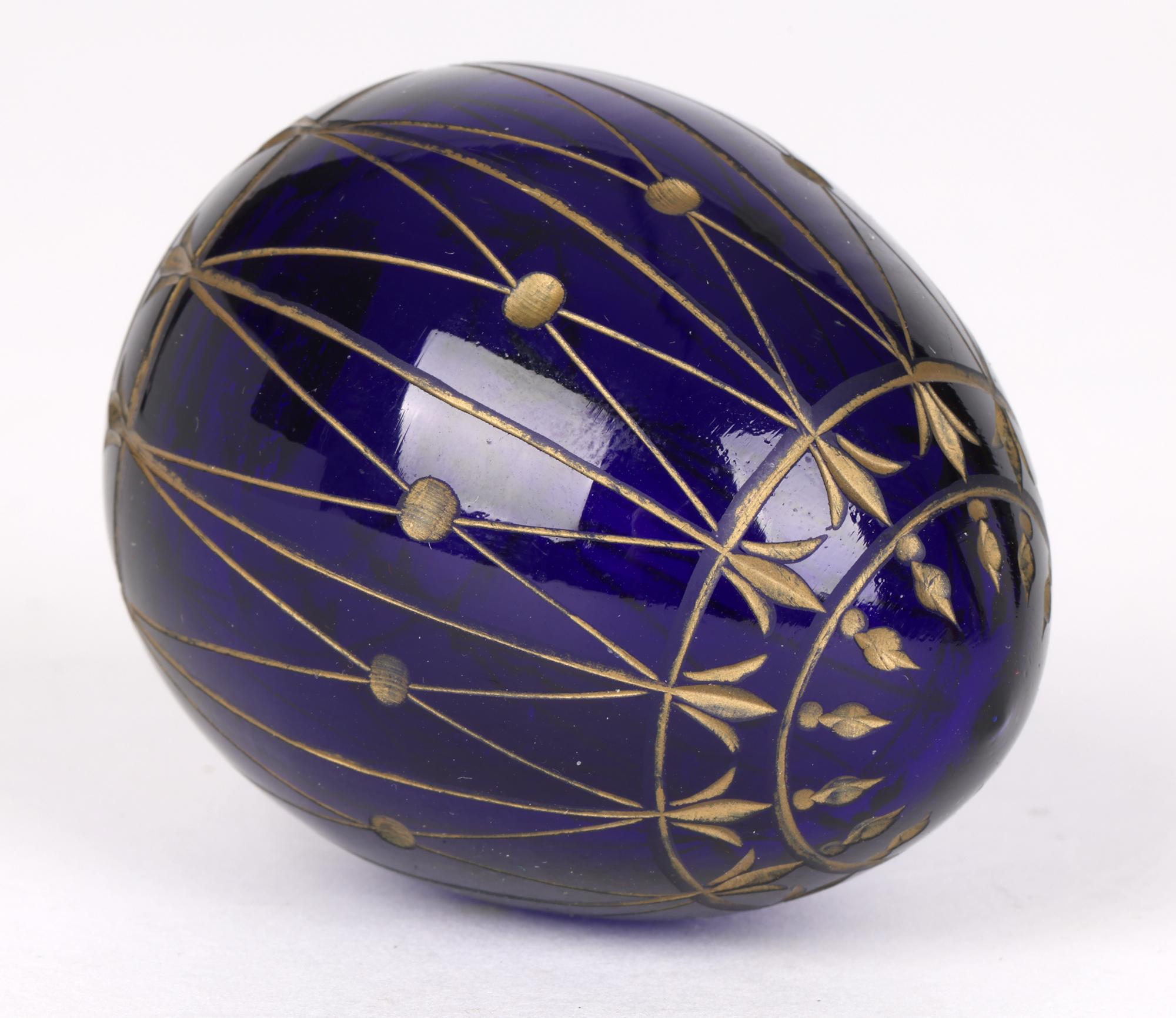 A fine quality vintage Russian hand-blown engraved cobalt blue glass egg with Faberge paper label to the base dating from the 20th century. The egg is finely made with a small flat base covered with a makers paper label. The body of the egg is