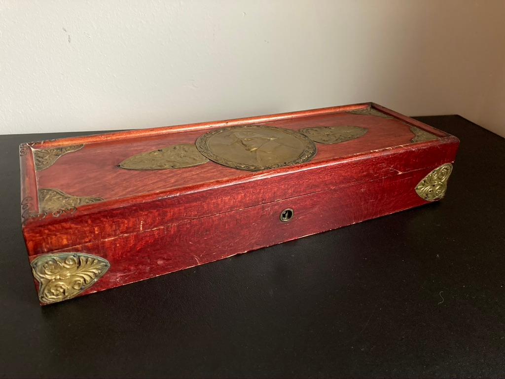 Early 20th century Russian wooden glove box with a brass repousse portrait of Emperor Napoleon on the lid. With incised carving and decoration brass repousse on the corners. Paper labels from Brocar Factories, Moscow, makers of cosmetics, soaps,