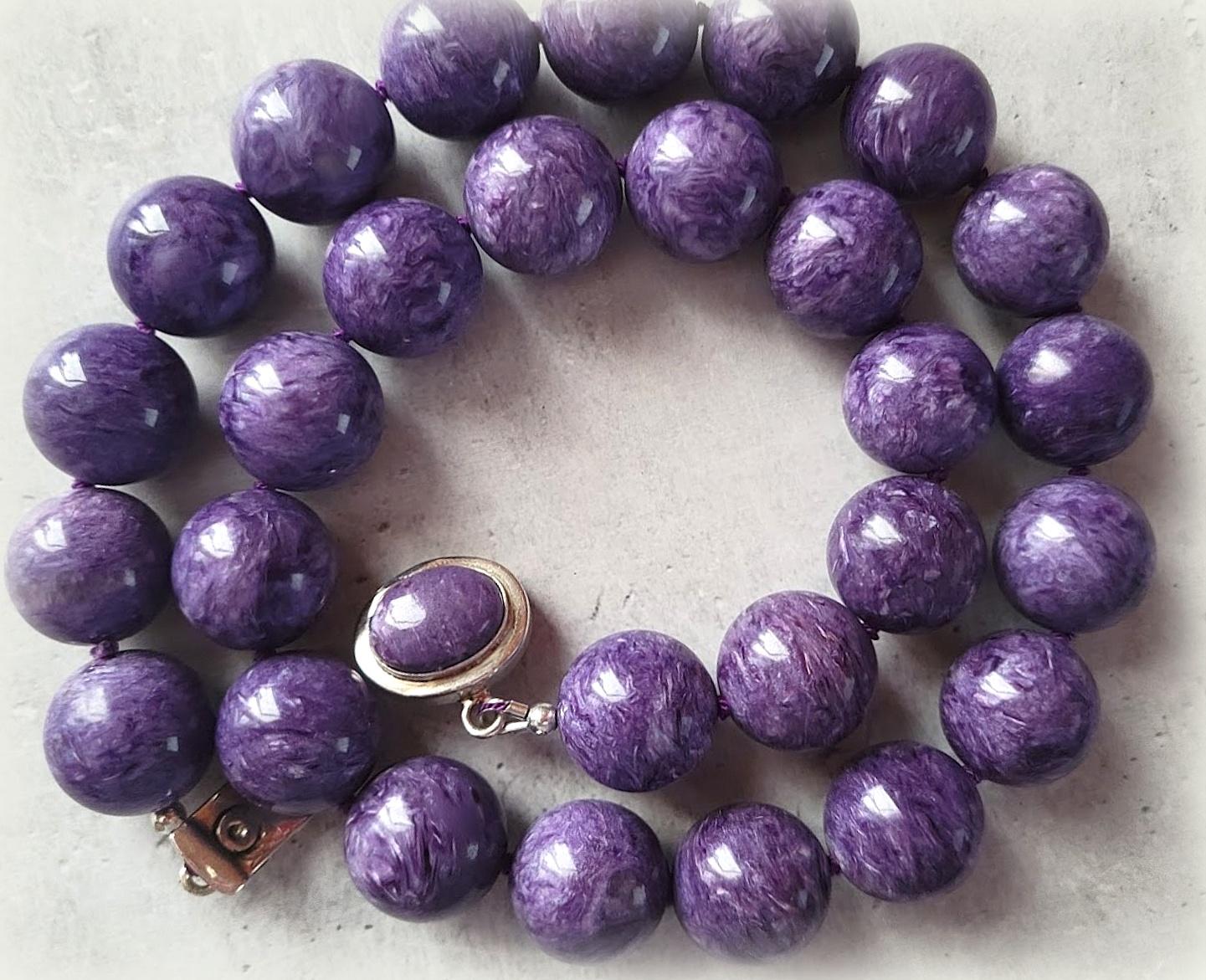 The length of the necklace is 20 inches (50.8 cm). The size of the smooth round beads is 16.5mm. Top-quality beads.
The color of the beads is unusual, deep with a bright shine and silk effect. Charoite color is non-uniform and can change its tone at