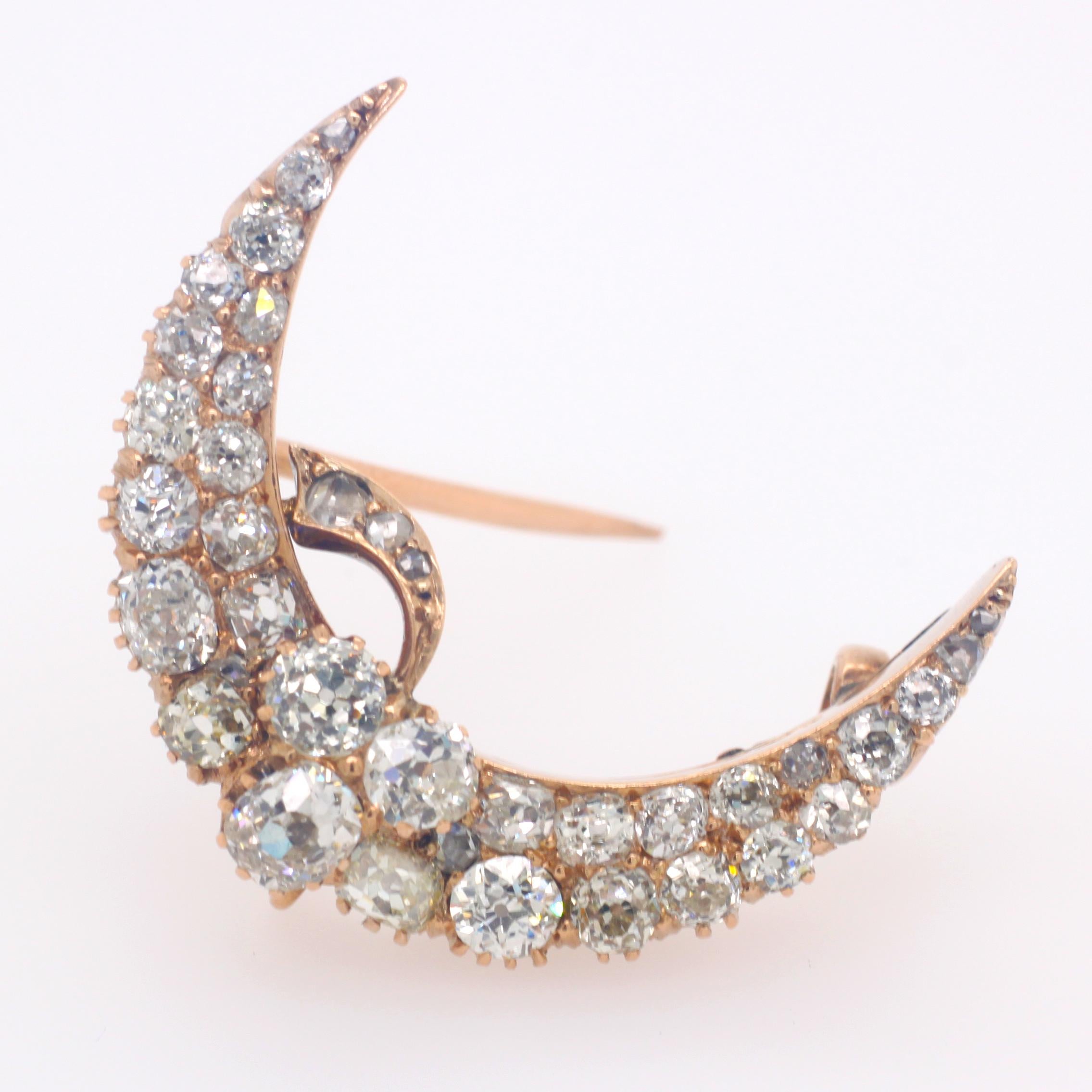 A Russian crescent moon and clover brooch in yellow gold, 1880s. The brooch, which has a loop and can be worn as a pendant, is set with old cut graduating diamonds, weighing approximately 3 carats. The brooch carries strong sentiments. Victorian