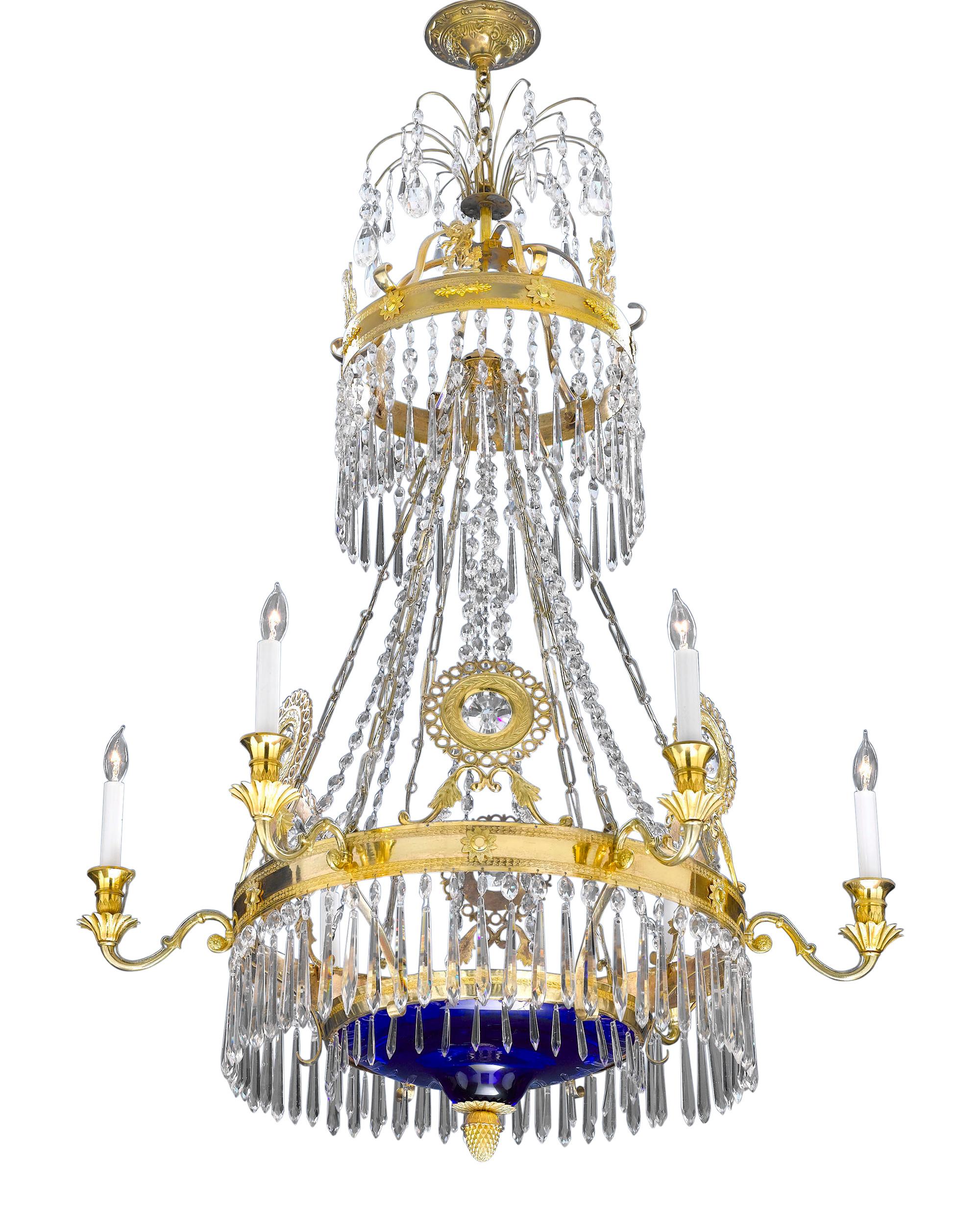 This Russian chandelier is distinguished by its exceptional rarity. The entirety of this important Neoclassical fixture is covered with a myriad of intricately cut glass lusters, all suspended from branches of hand-crafted ormolu. An elegant cobalt