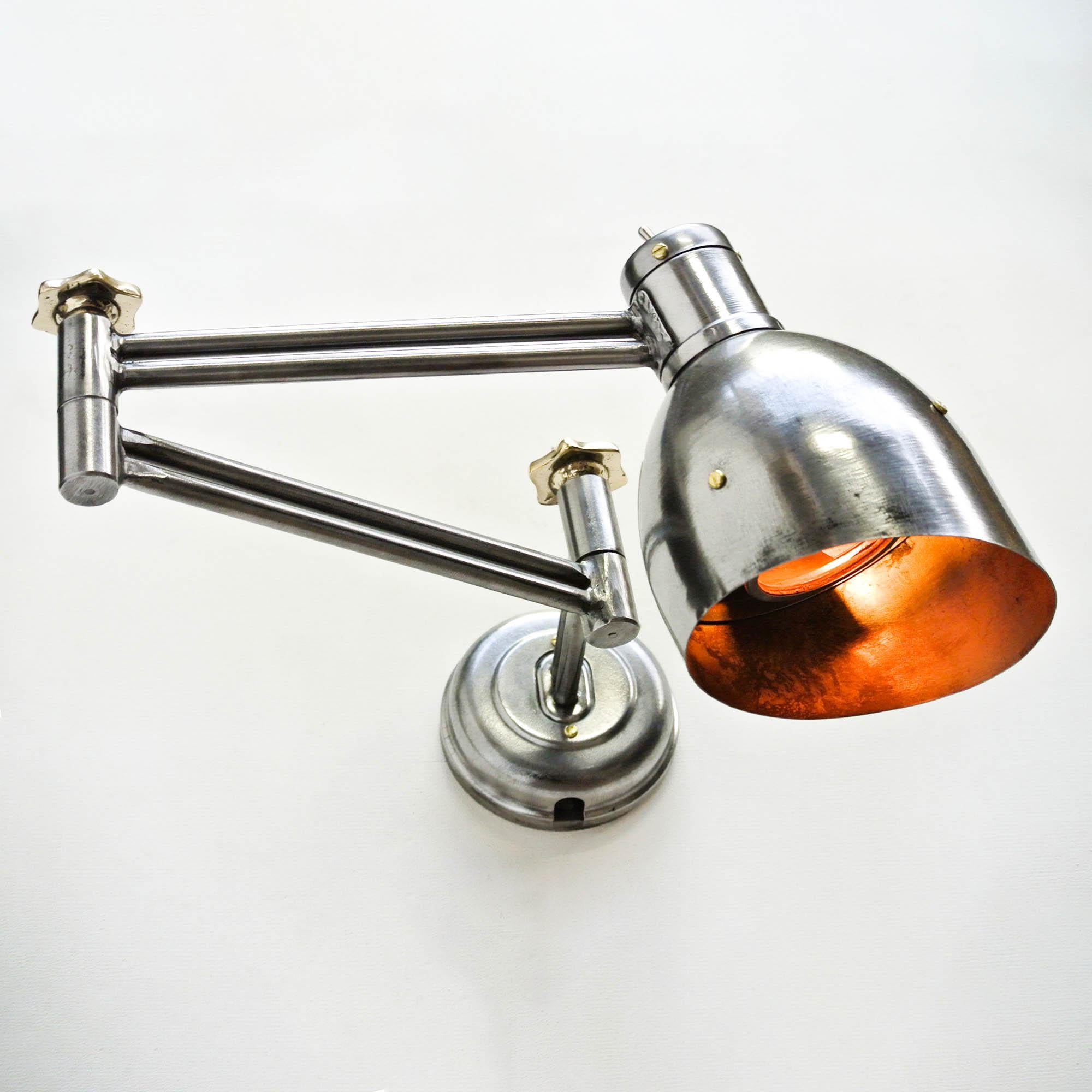 This old lamp originally used in manufacturing workshop in ex-Russia (URSS), is made of steel (stripped, brushed, polished, varnished), and adjustment wheels made of brass at each end of strenghtened articulated arms. Base in pressed steel allowing