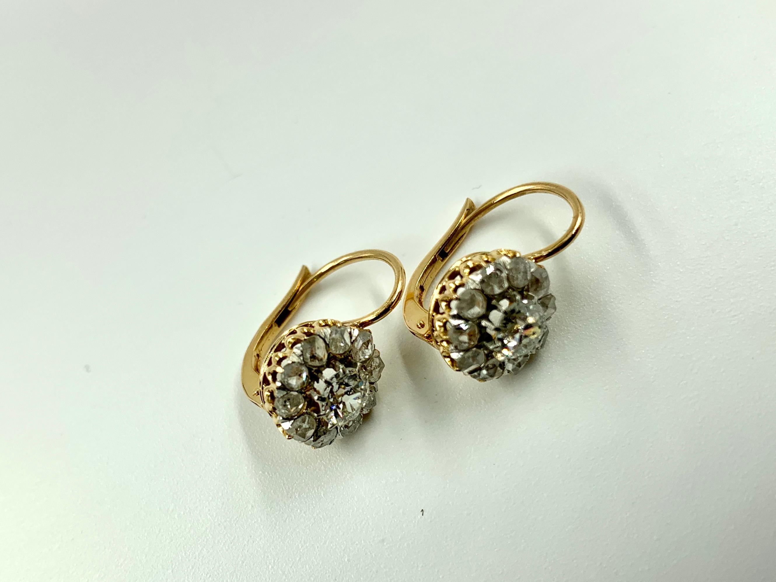 Classic Russian diamond flower form earrings with central full cut diamonds each surrounded by ten smaller old mine cut diamonds forming the petals set in 14k gold (tested) unmarked, approximately 2 carat total weight. 
Dormeuse is french for