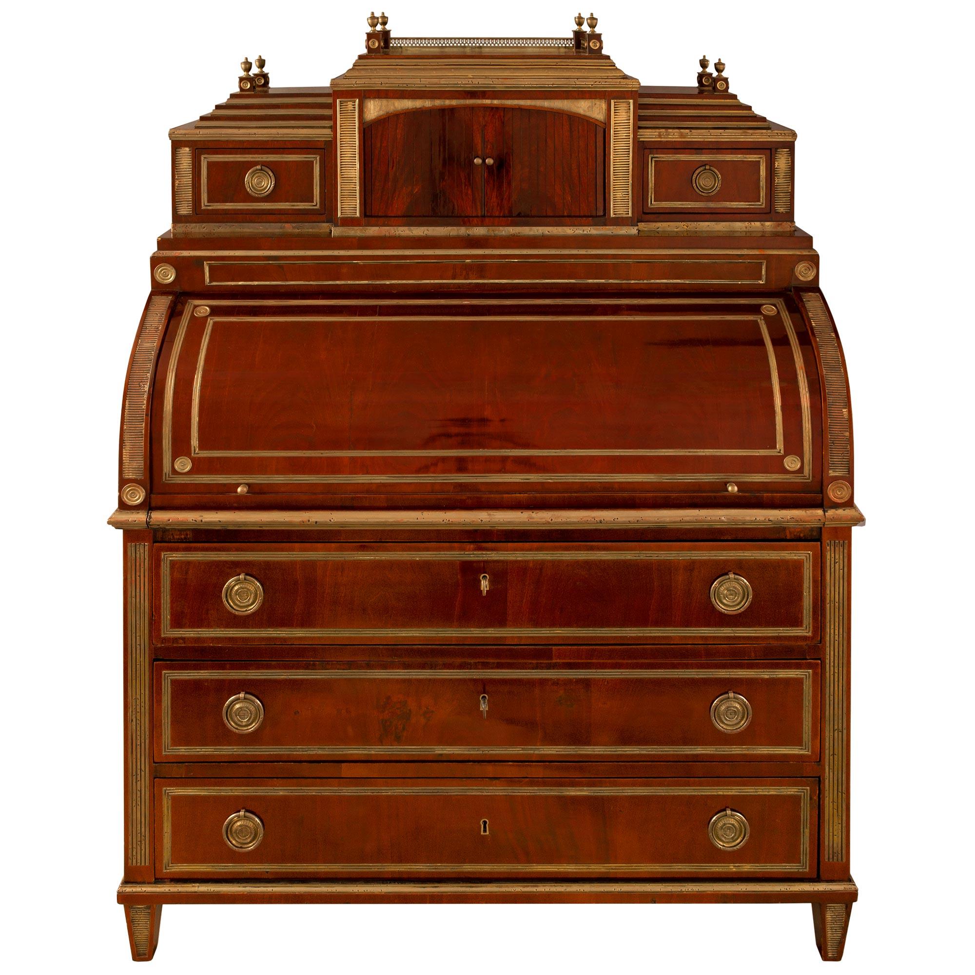 A very high quality and spectacular Russian early 19th century Empire style mahogany ' Bureau a Cylindre' with all original gilt and hardware. The square feet with brass reeded plaques below three large drawers bordered with brass filets have ormolu